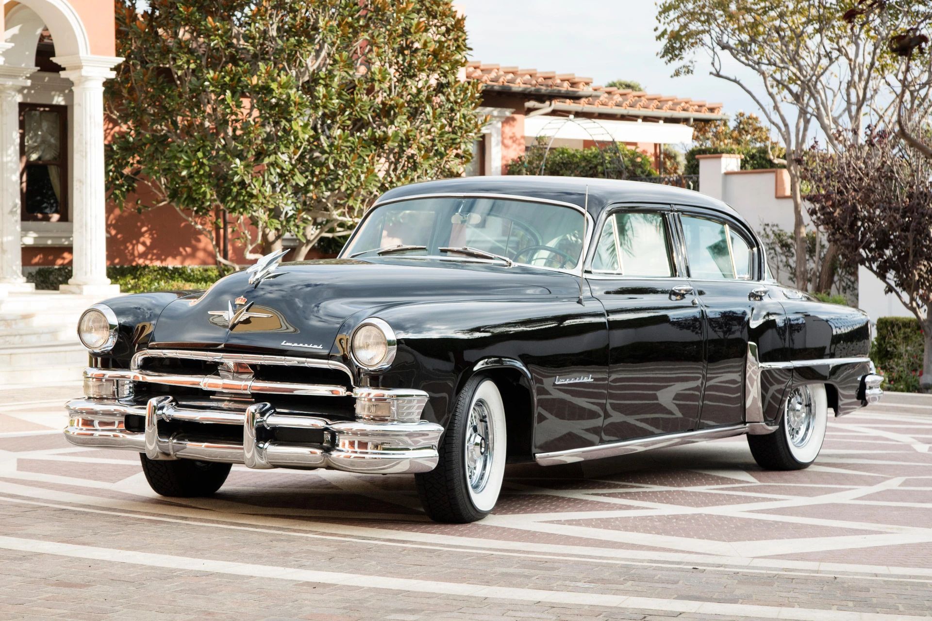 Left front 3q view of a black 1953 Chrysler C-58 Custom Imperial sedan with wire wheels