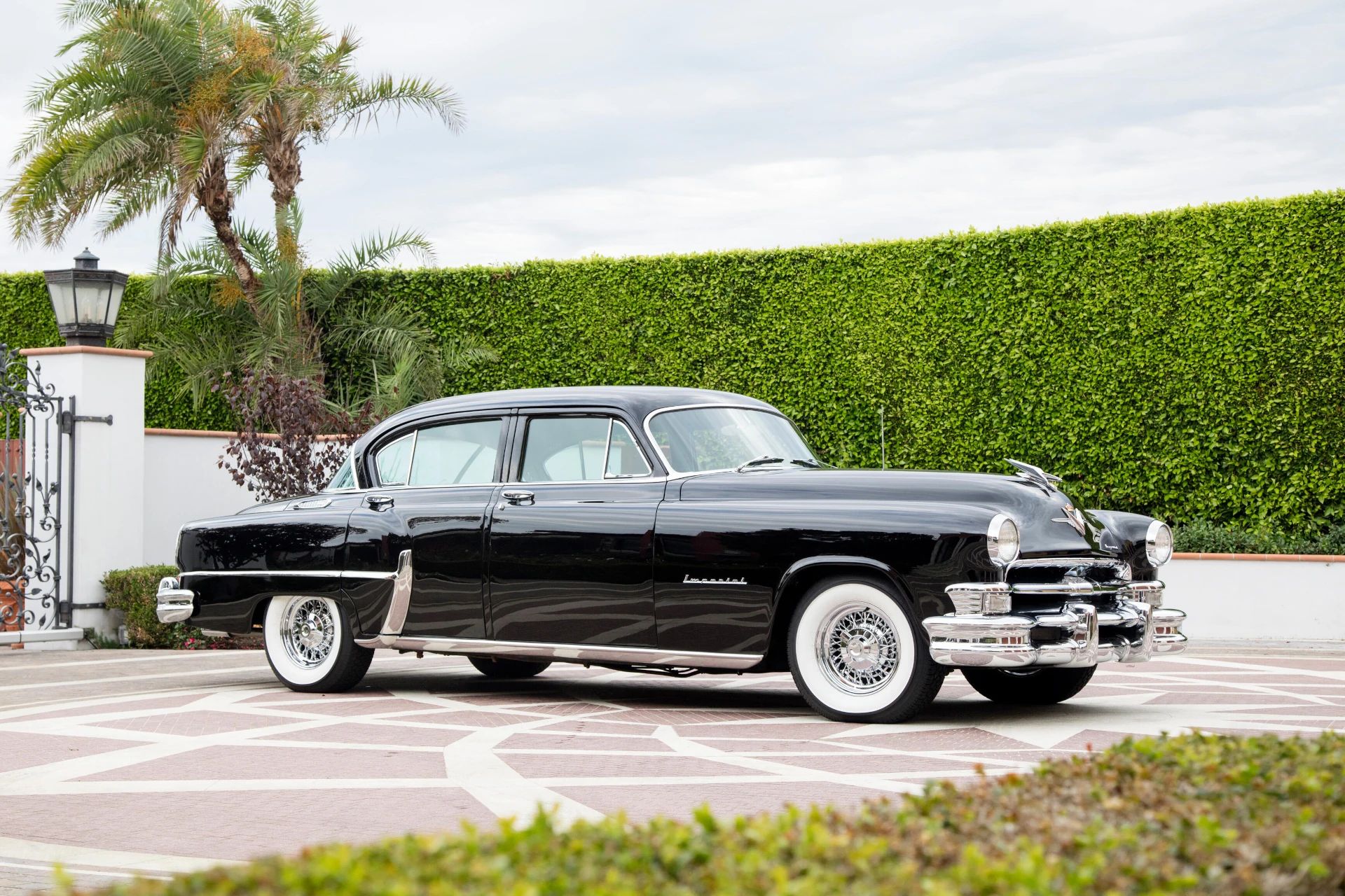 Right front 3q view of a black 1953 Chrysler C-58 Custom Imperial sedan with wire wheels