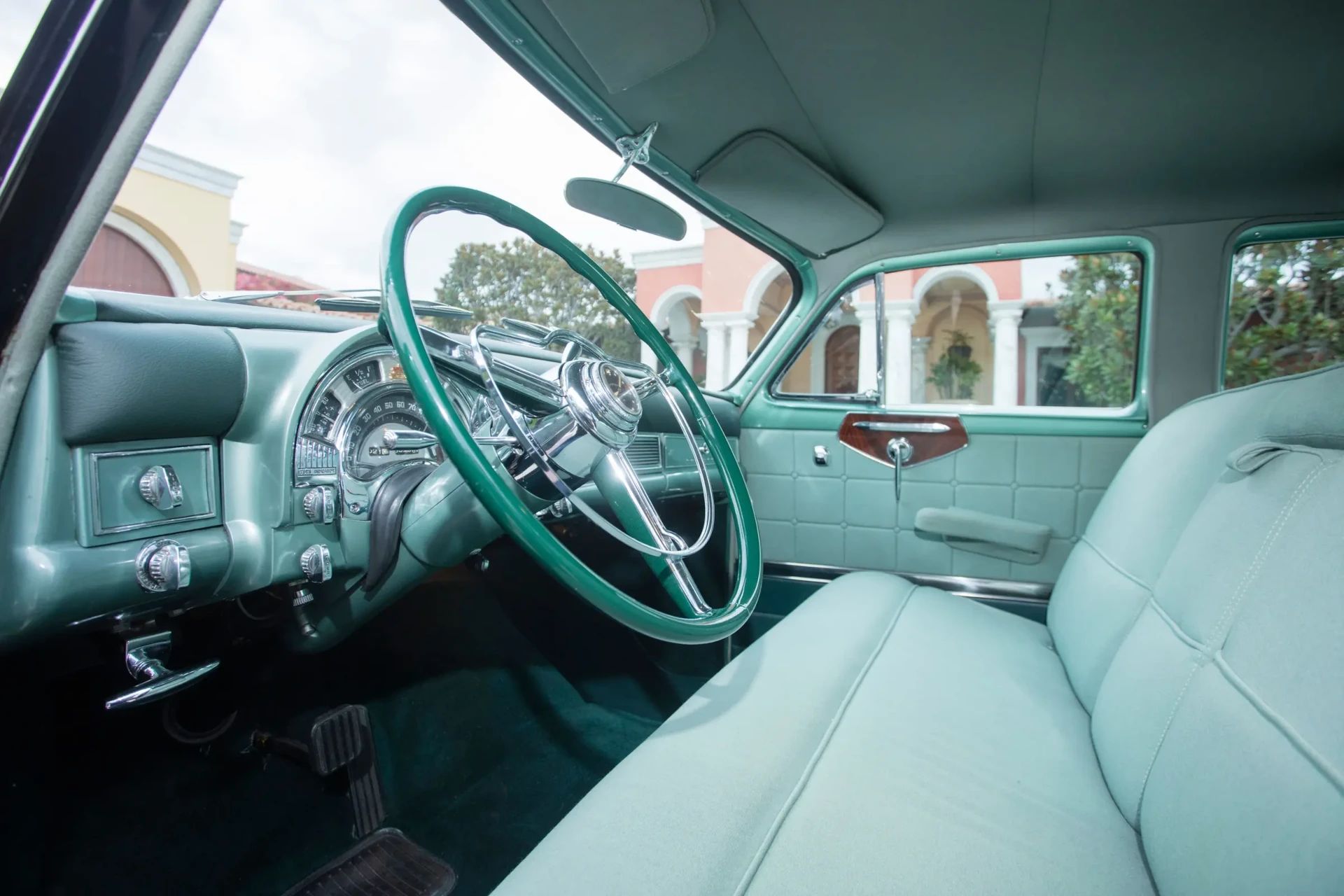 Front bench seat of a 1953 Chrysler C-58 Custom Imperial with green interior