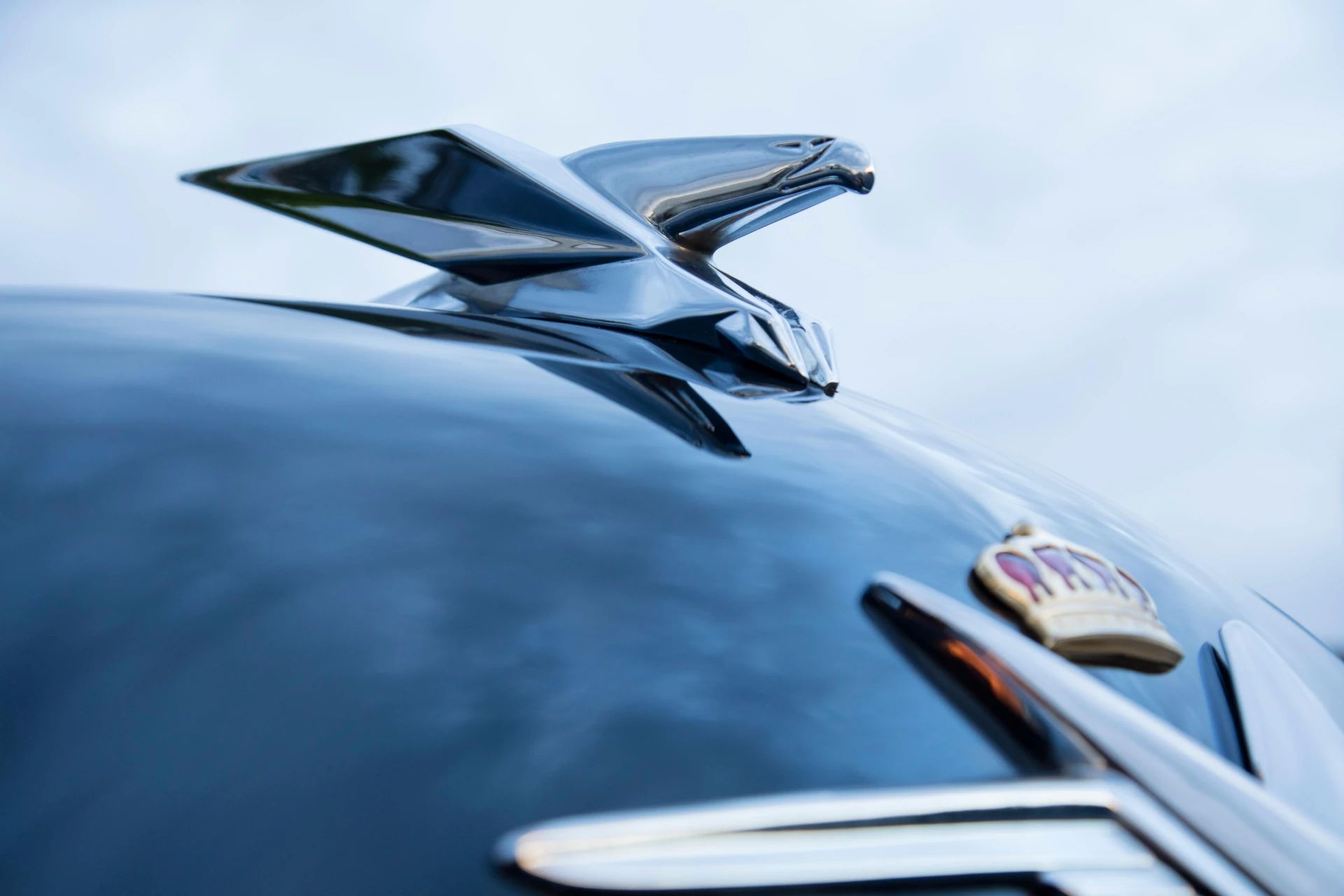 Eagle hood ornament on the hood of a black 1953 Chrysler Custom Imperial