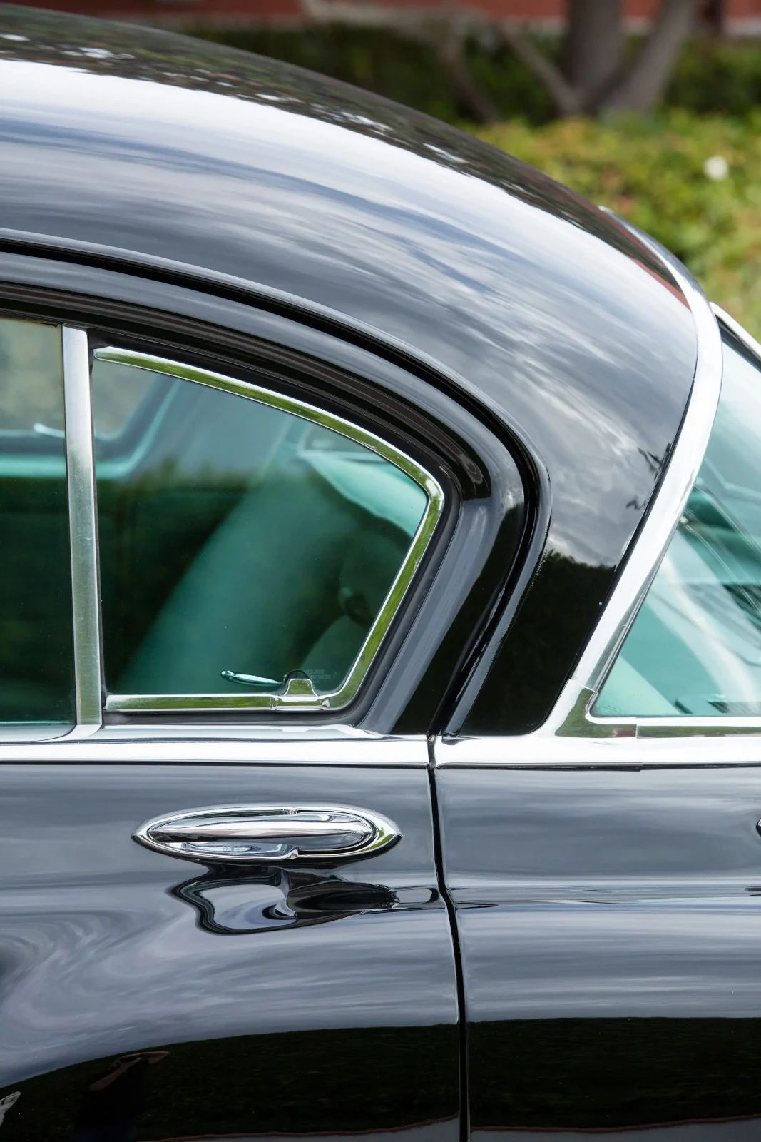 Left rear vent window of a black 1953 Chrysler C-58 Custom Imperial