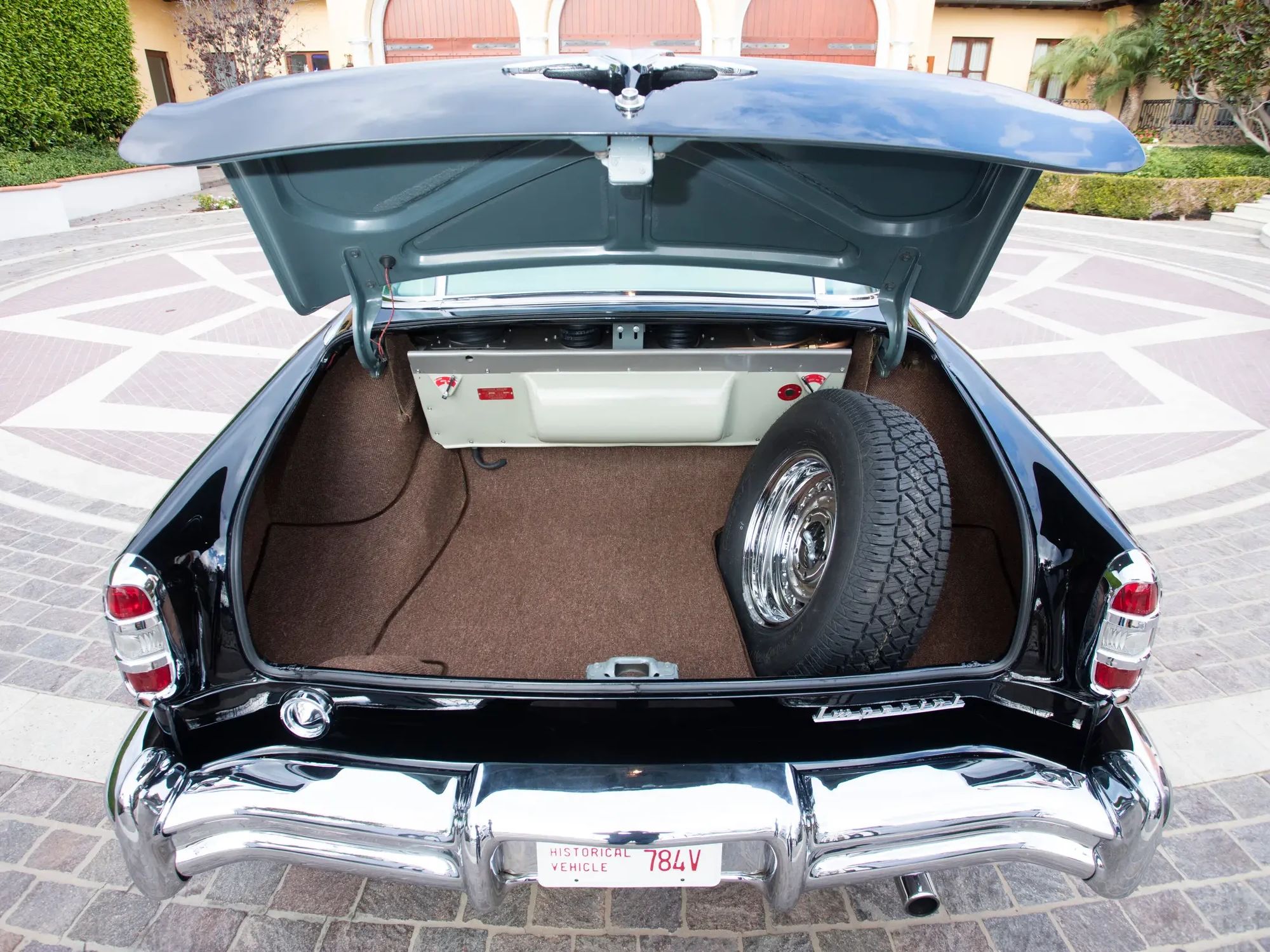 Trunk and spare tire of a 1953 Chrysler C-58 Custom Imperial, revealing the boxy shape of the Airtemp air conditioner installation