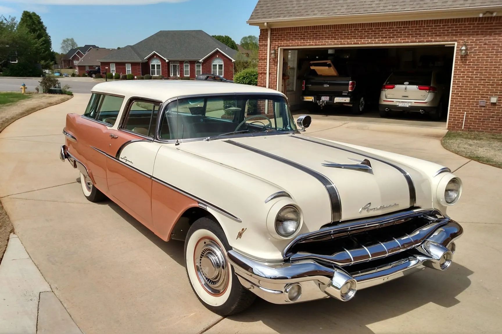 Right front 3q view of a two-tone coral and beige 1956 Pontiac Star Chief station wagon