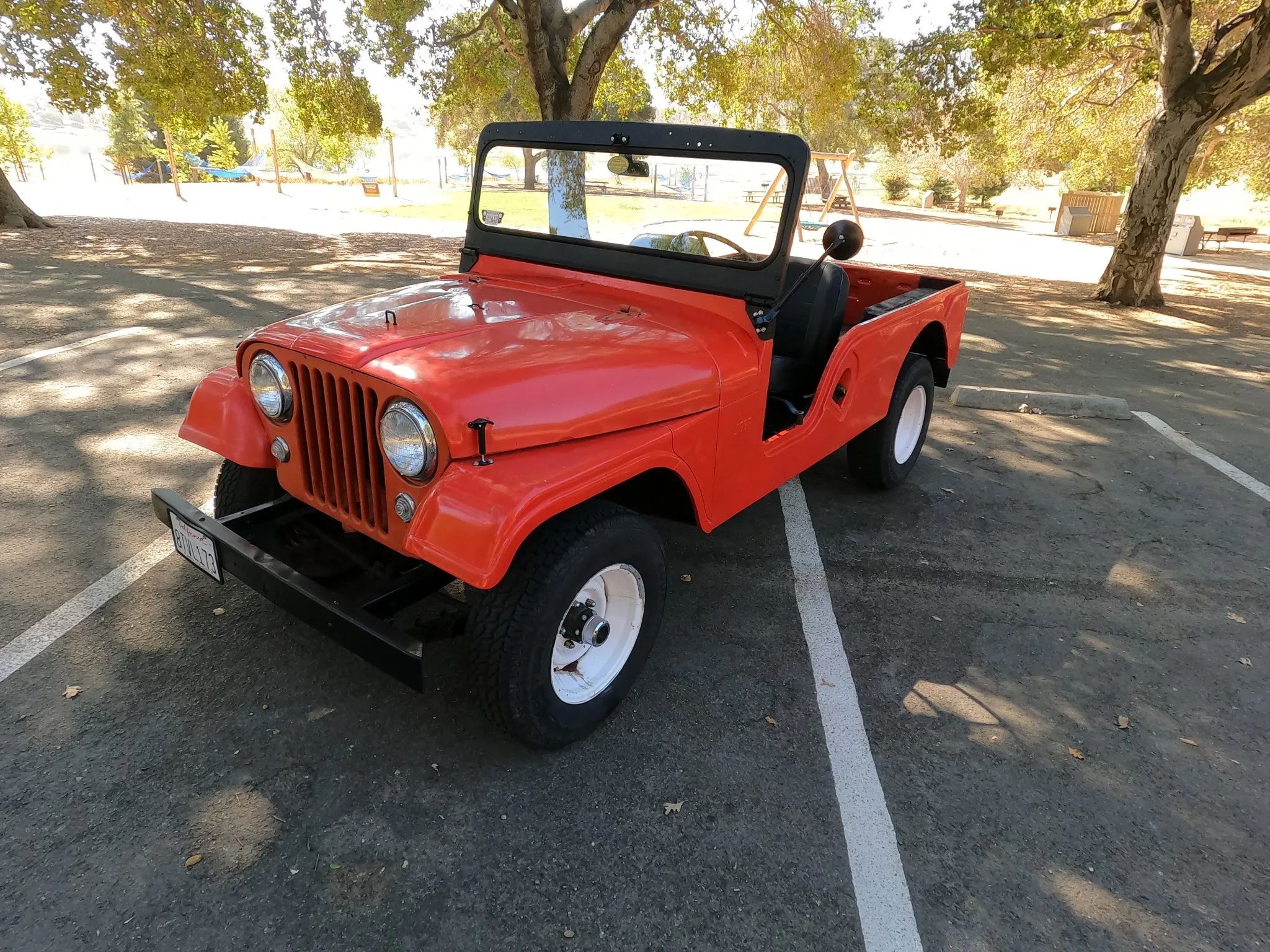 Vintage Ads: How Willys Jeep Tried To Lure Jeep Dealers In The 1950s And Early 1960s 5 Left front 3q view of a red 1956 Jeep CJ-6 in a parking lot under some trees