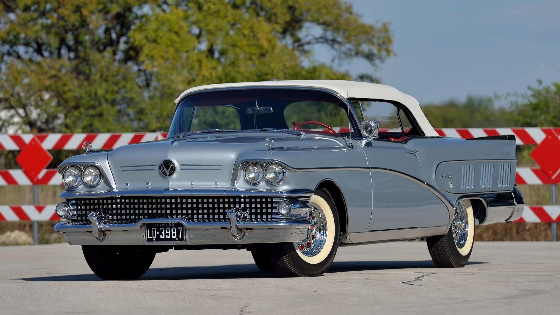 Left front 3q view of a silver 1958 Buick Limited convertible with its white top up