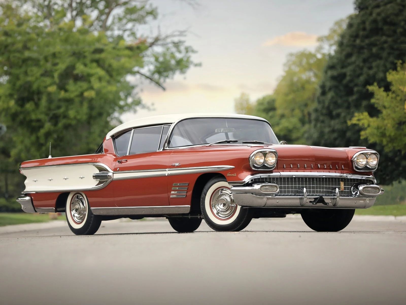 Right front 3q view of a two-tone red and white 1958 Pontiac Bonneville two-door hardtop