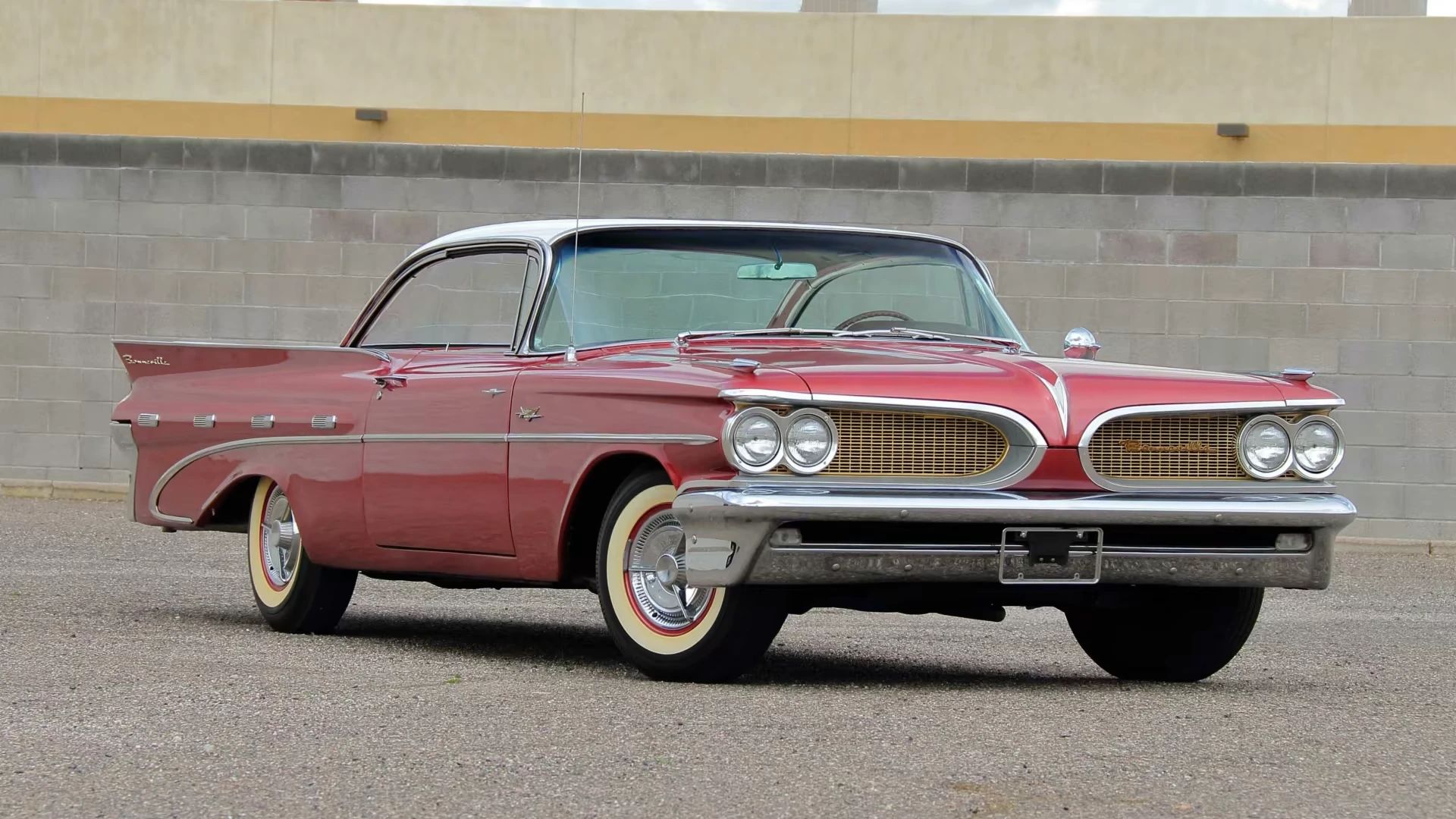 Right front 3q view of a red 1959 Pontiac Bonneville "bubbletop" two-door hardtop with a white roof