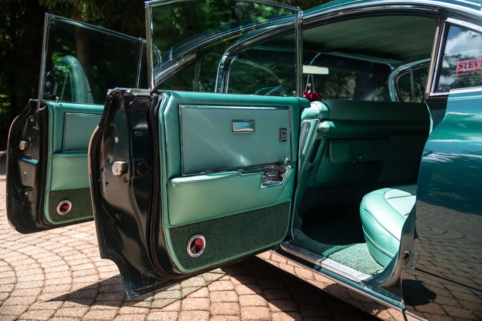 1960 Cadillac Fleetwood Sixty Special: Enviably Green, But No A/C 8 Left side of a green 1960 Cadillac Fleetwood Sixty Special four-door hardtop, with the doors open to reveal the green interior