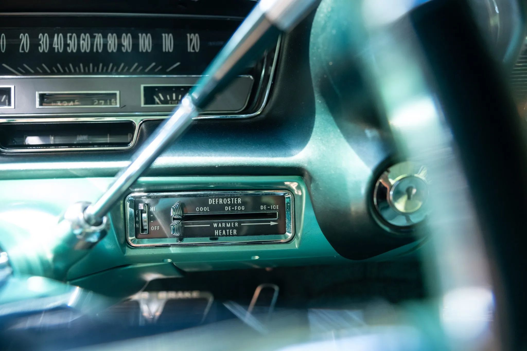 1960 Cadillac Fleetwood Sixty Special: Enviably Green, But No A/C 4 Heater controls of a 1960 Cadillac with a green interior, viewed through the steering wheel rim