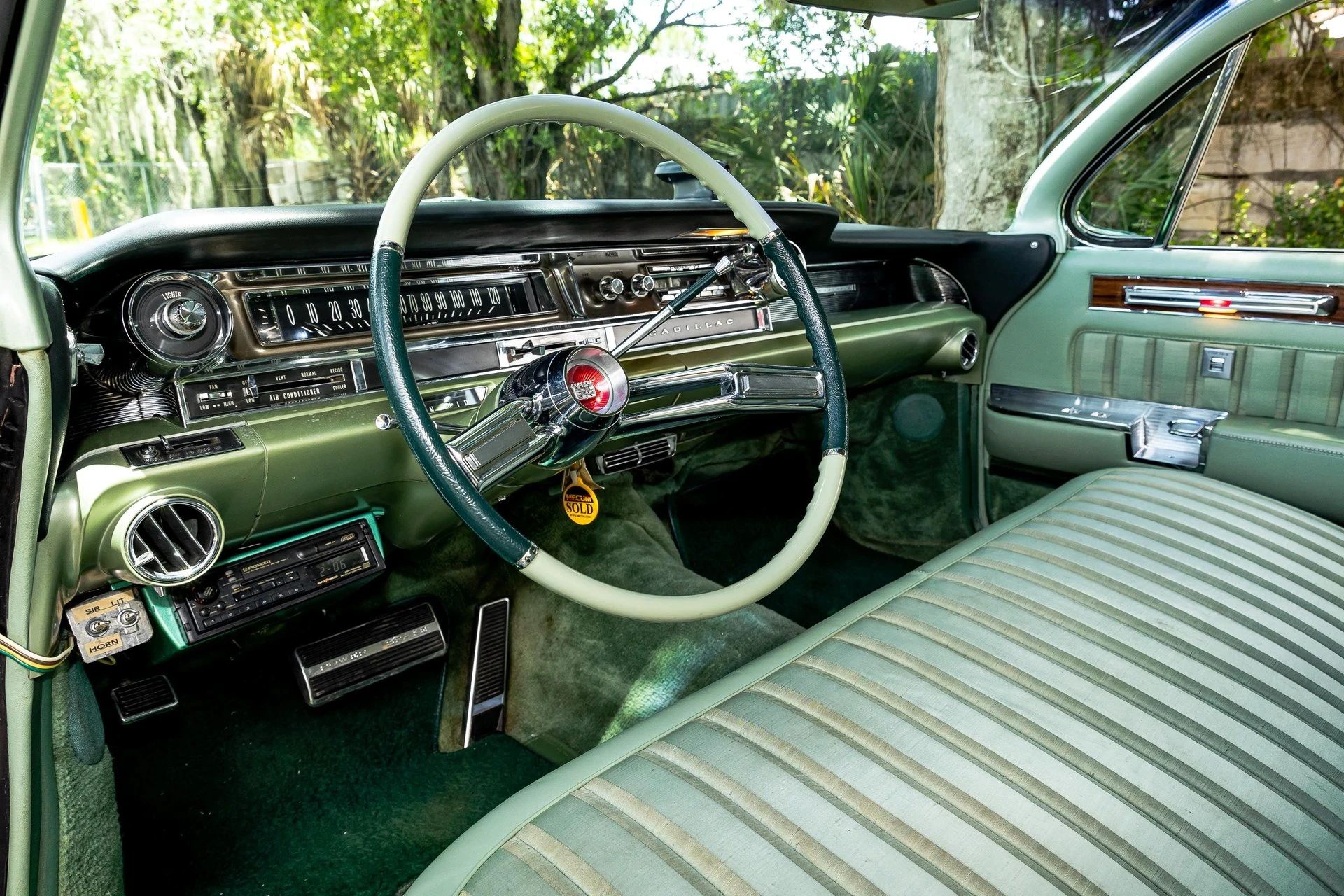 1960 Cadillac Fleetwood Sixty Special: Enviably Green, But No A/C 25 Dashboard of a 1961 Cadillac Fleetwood Sixty Special with green striped upholstery and a two-tone green steering wheel