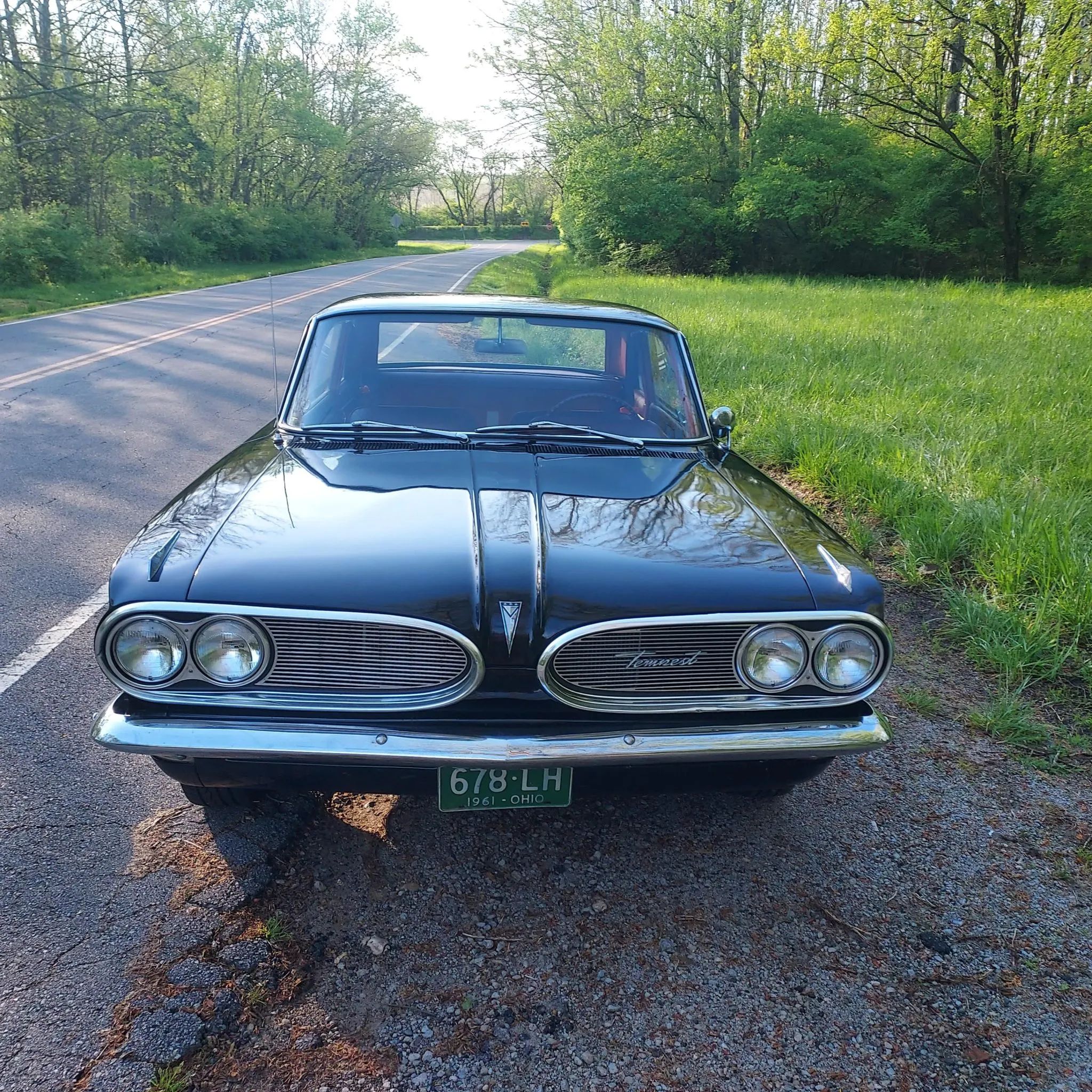 High-angle front view of a black 1961 Pontiac Tempest coupe