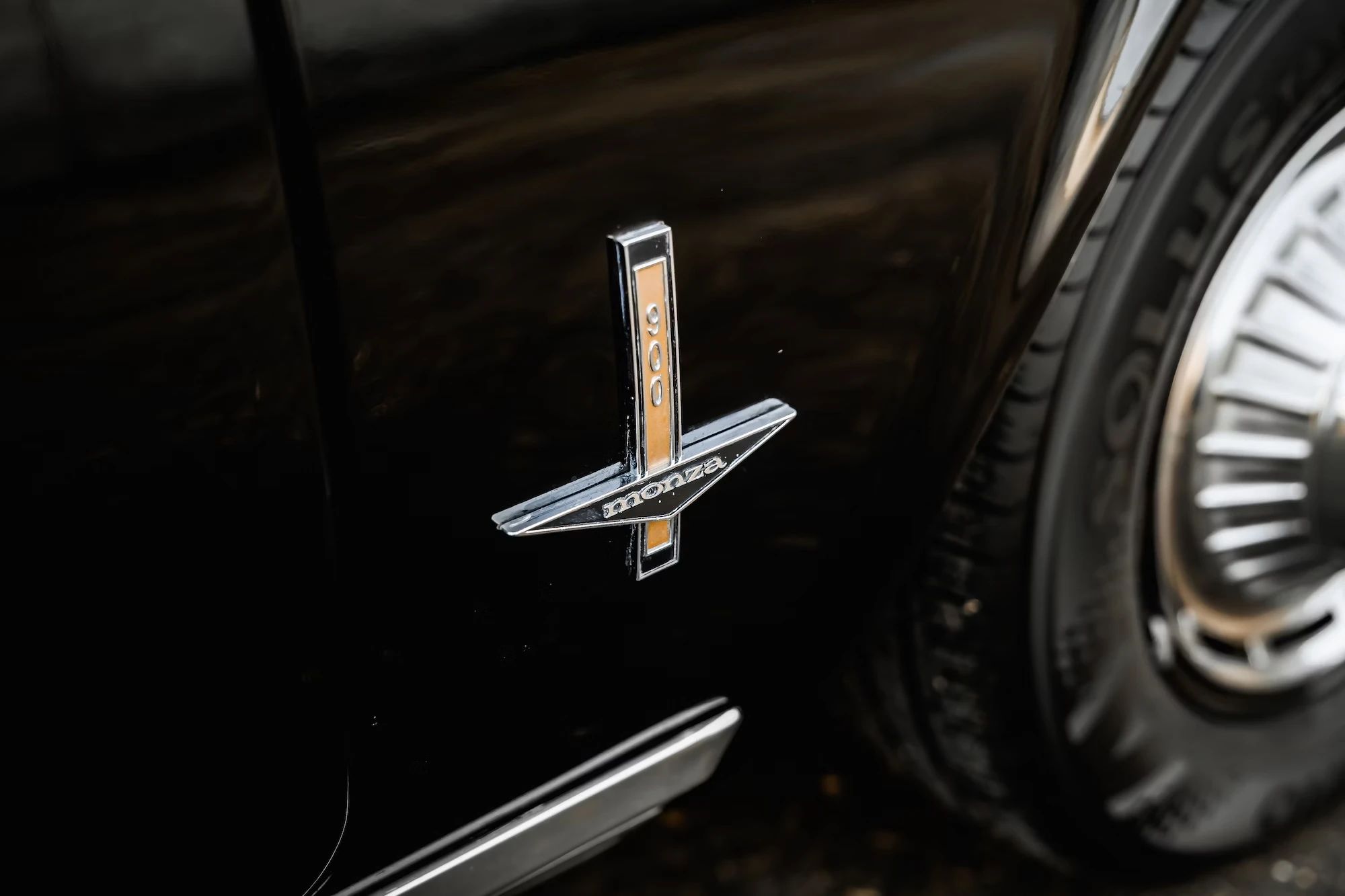Monza 900 badge on the fender of a black 1962 Chevrolet Corvair