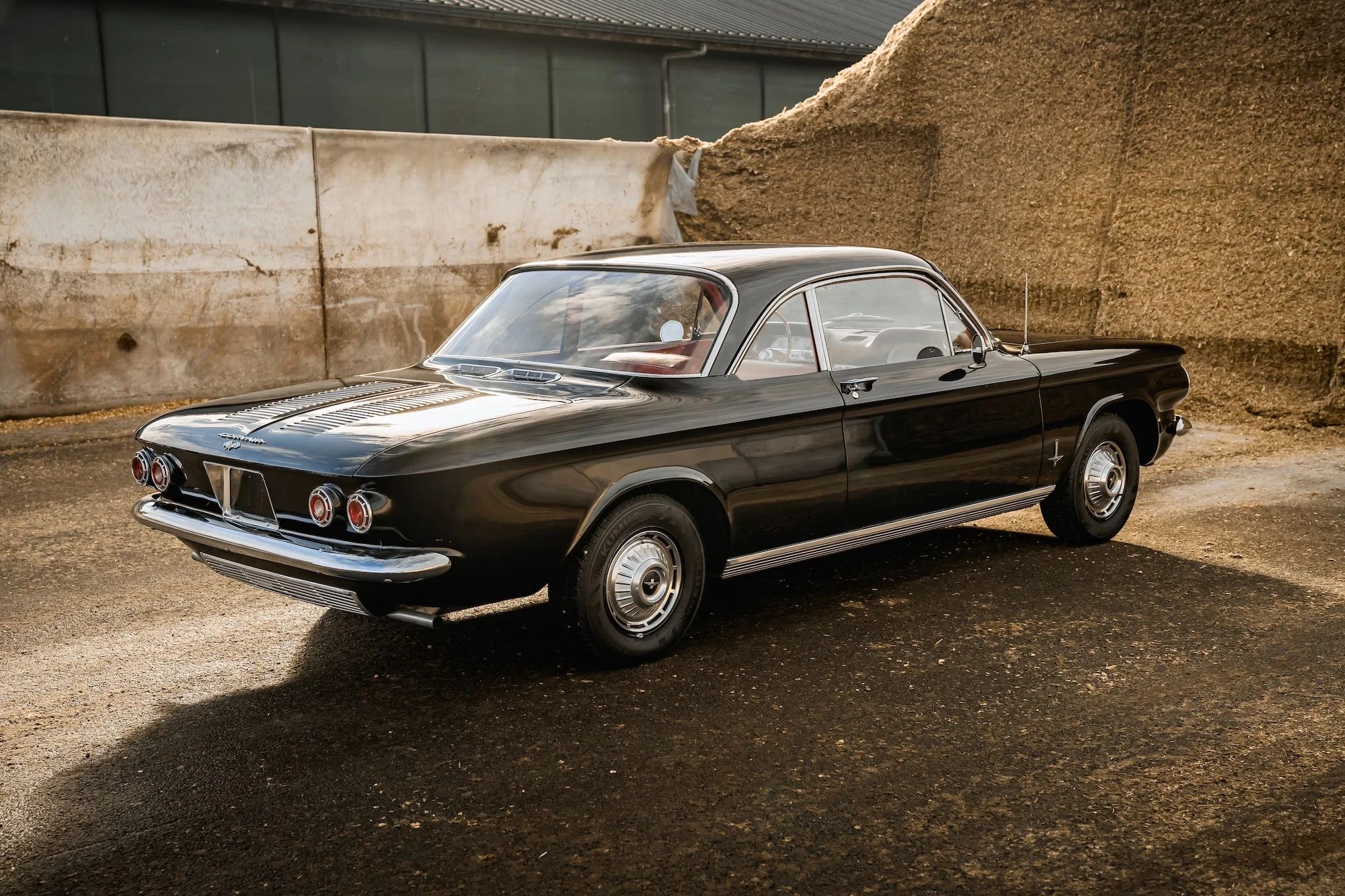 Right rear 3q view of a black 1962 Chevrolet Corvair coupe