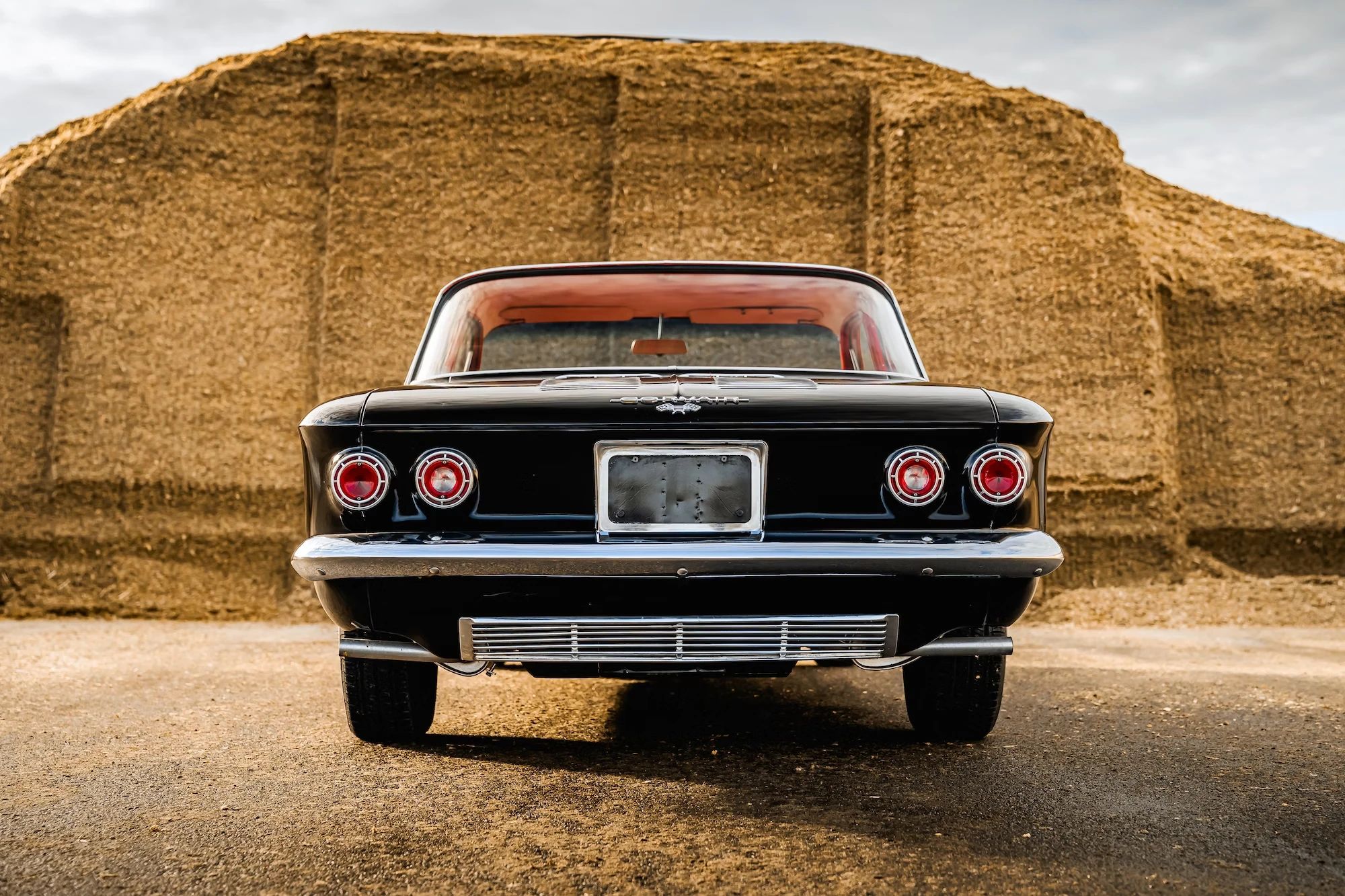 Rear view of a black 1962 Chevrolet Corvair coupe