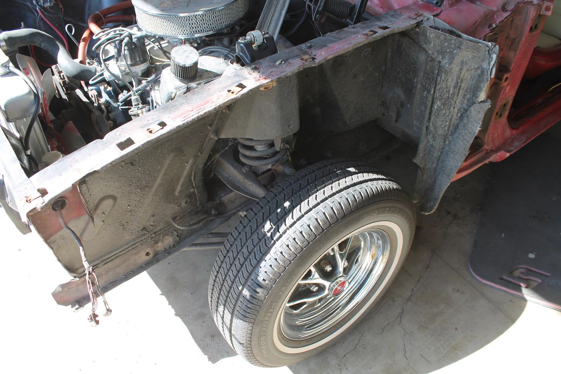 CC Tech: How the Mustang, Cougar, And Maverick Differed From The Original Ford Falcon Platform 14 Left front wheel and suspension of a 1965 Ford Mustang with the front fender removed