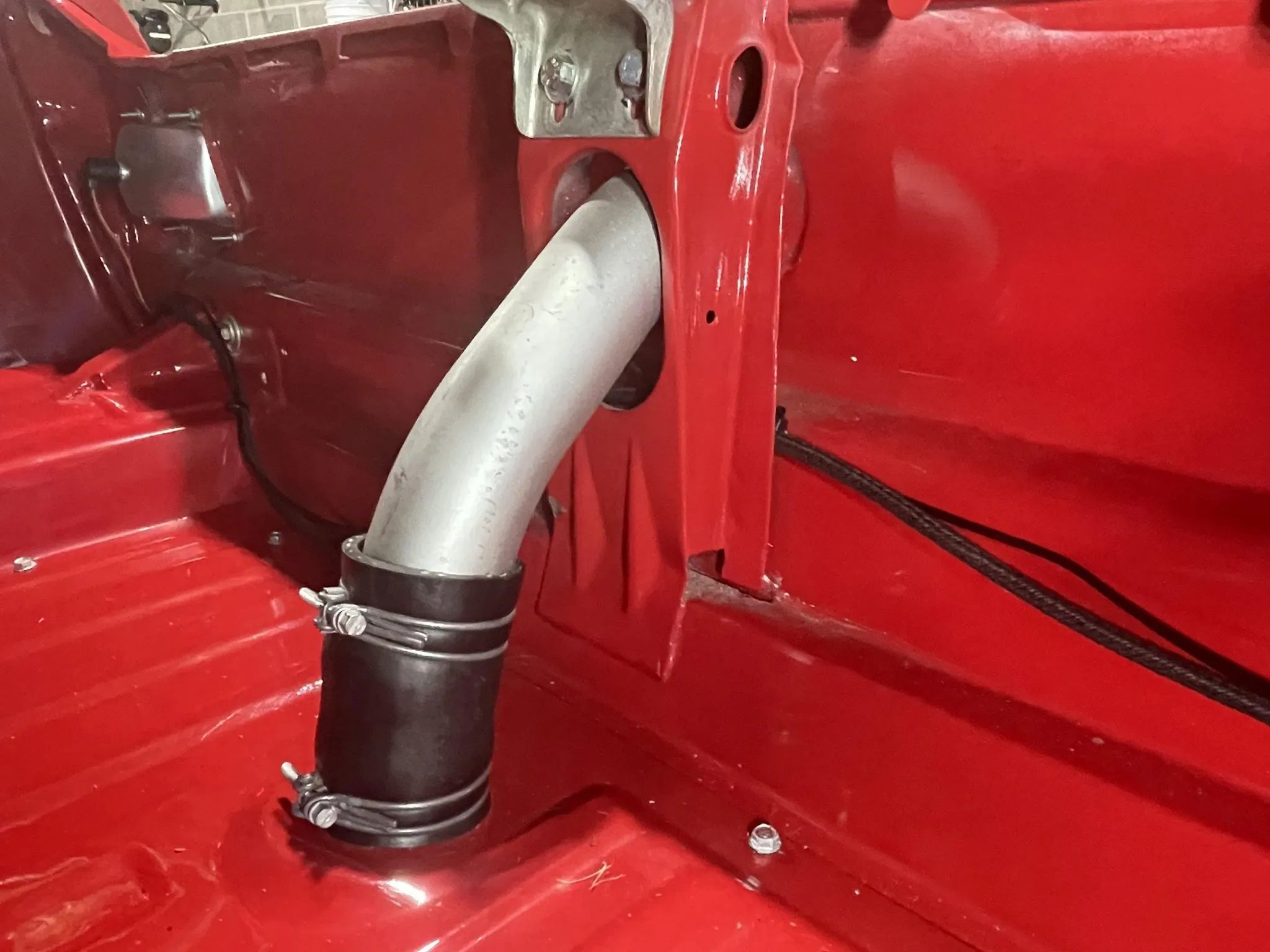 Fuel filler in the trunk of a red 1966 Ford Mustang fastback
