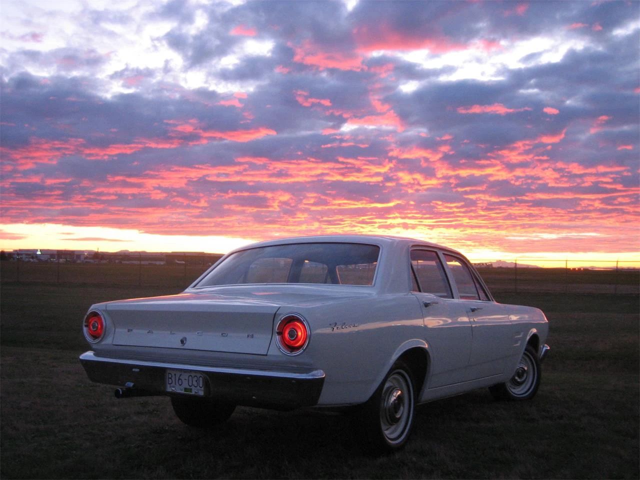 1967 Ford Falcon Sedans: Deeply Un-Hip Survivors That Have Somehow Beaten The Odds 20 Right rear 3q view of a white 1967 Ford Falcon sedan with its taillights lit, beneath a spectacular sunset