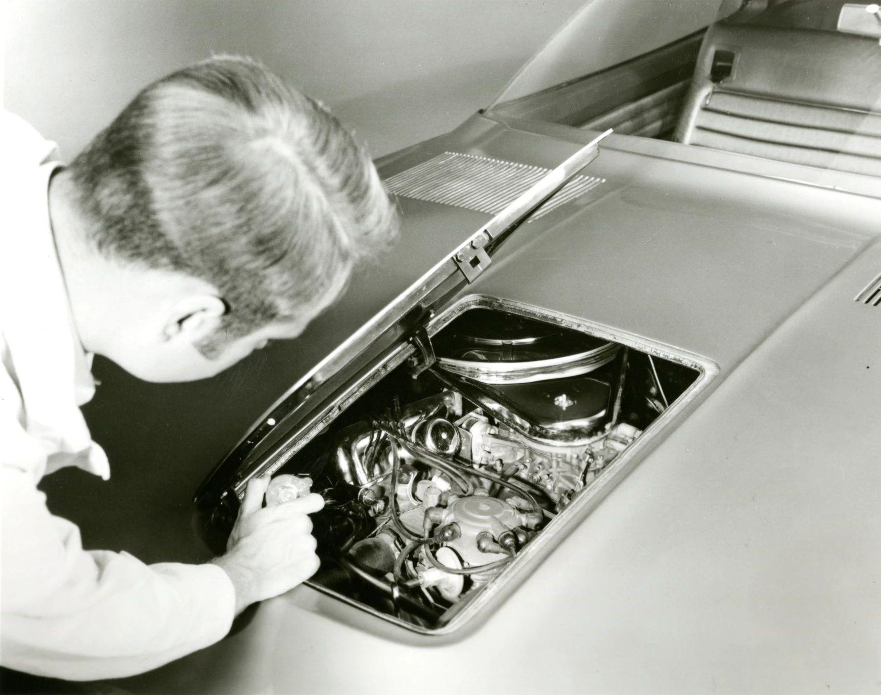 1968 Ford Techna Concept Car: Retro-Future Anachronism With A Weird Offset Driveshaft And Power Doors 19 B&W photo of a technician demonstrating the service access panel in the top of the hood of the Ford Techna concept car