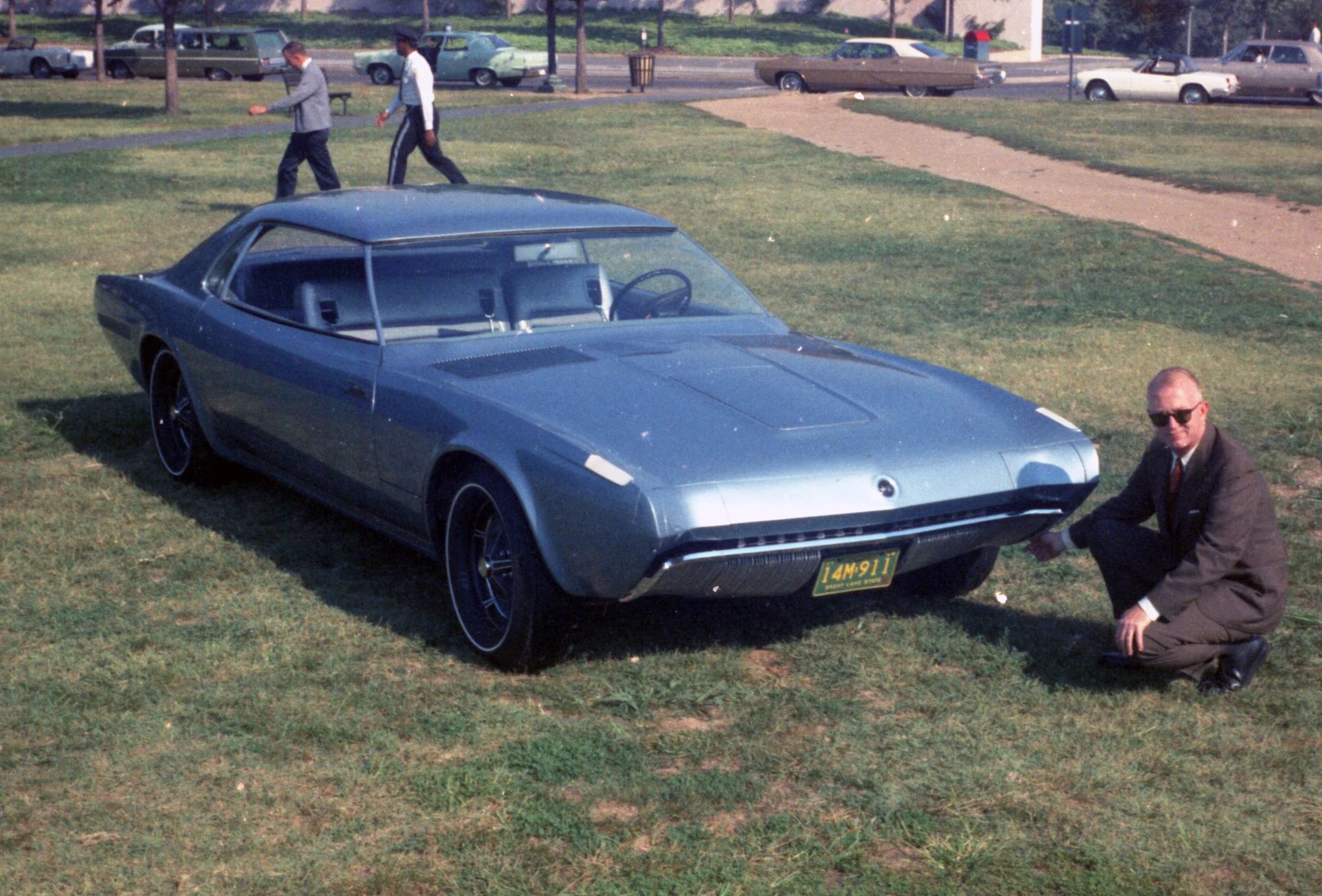 1968 Ford Techna Concept Car: Retro-Future Anachronism With A Weird Offset Driveshaft And Power Doors 25 Photo of the 1968 Ford Techna on a lawn with a man in a suit and sunglasses kneeling by the nose