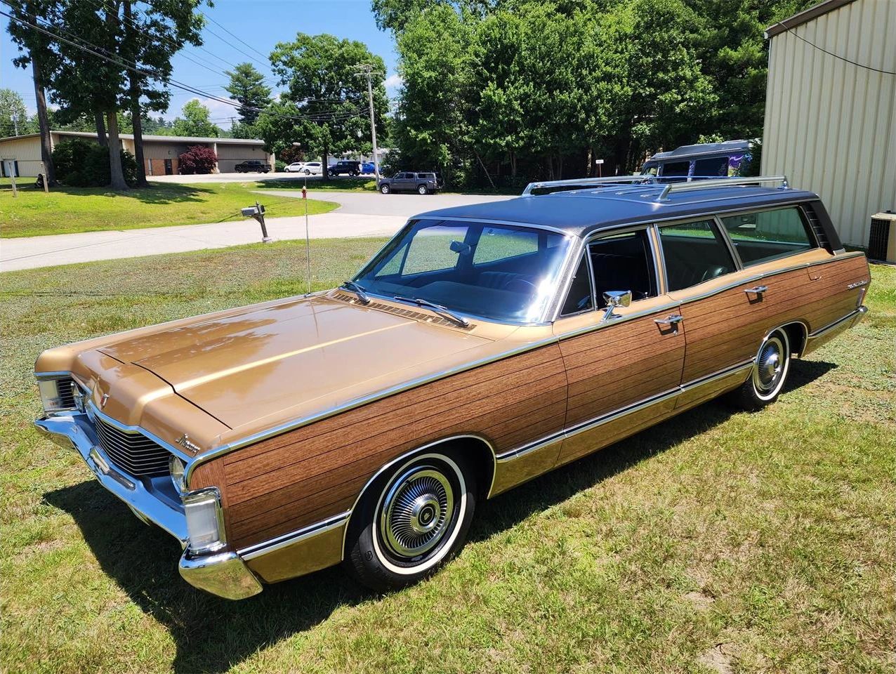 Left front 3q view of a gold 1968 Mercury Colony Park station wagon with simulated woodgrain side trim
