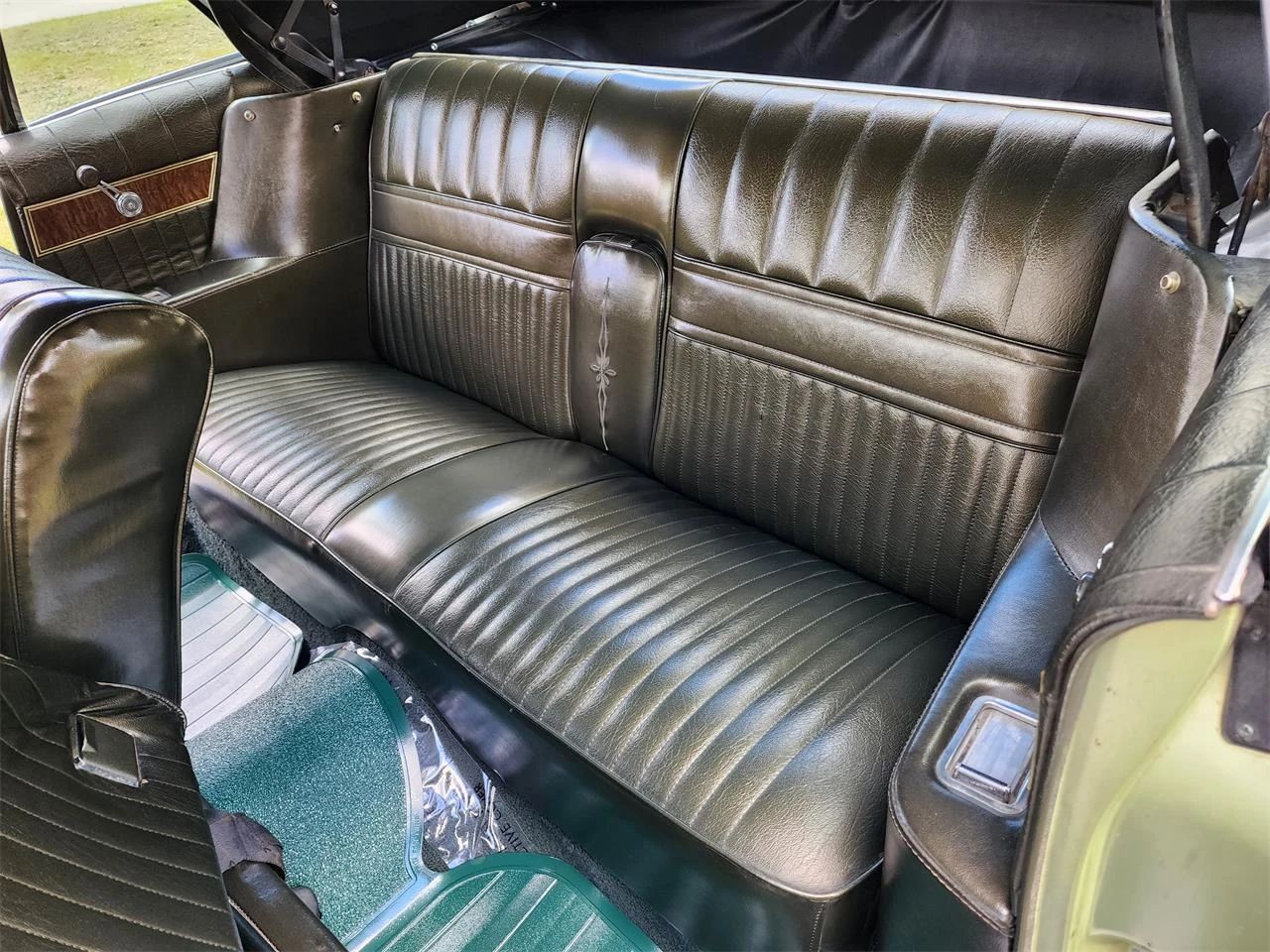 Back seat of a 1968 Mercury Park Lane convertible with dark green vinyl trim