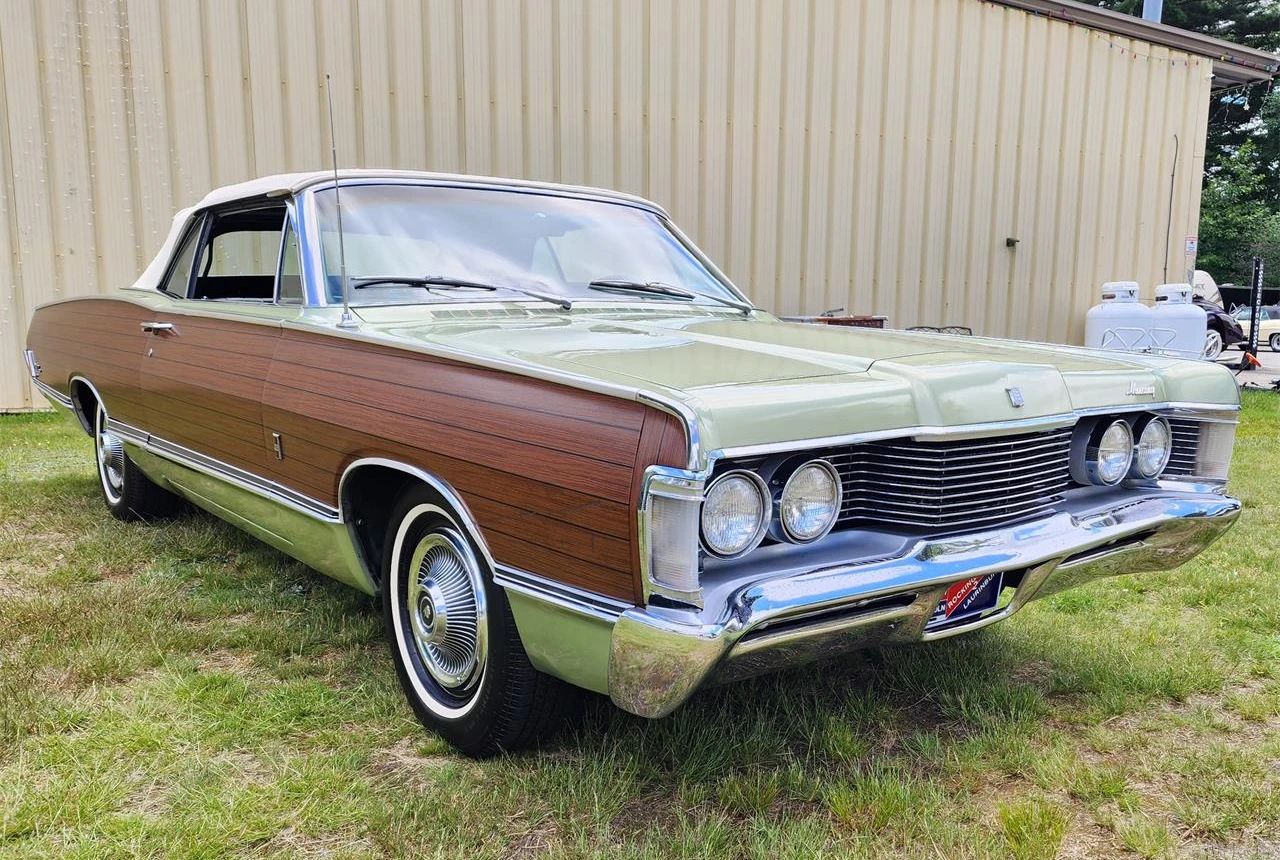 Right front 3q view of a metallic green 1968 Mercury Park Lane convertible with simulated woodgrain side trim