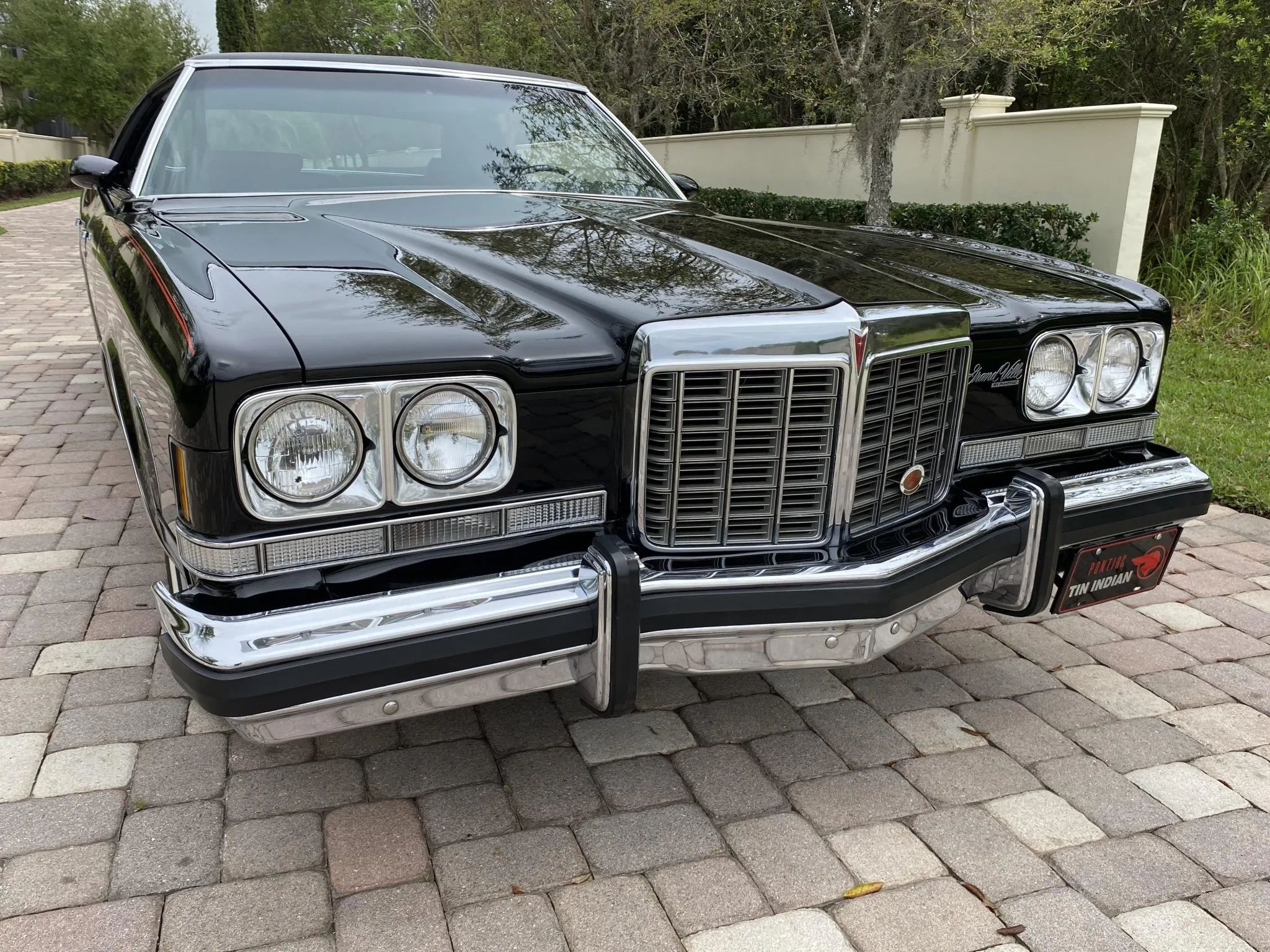 Front view of a black 1974 Pontiac Grand Ville four-door sedan