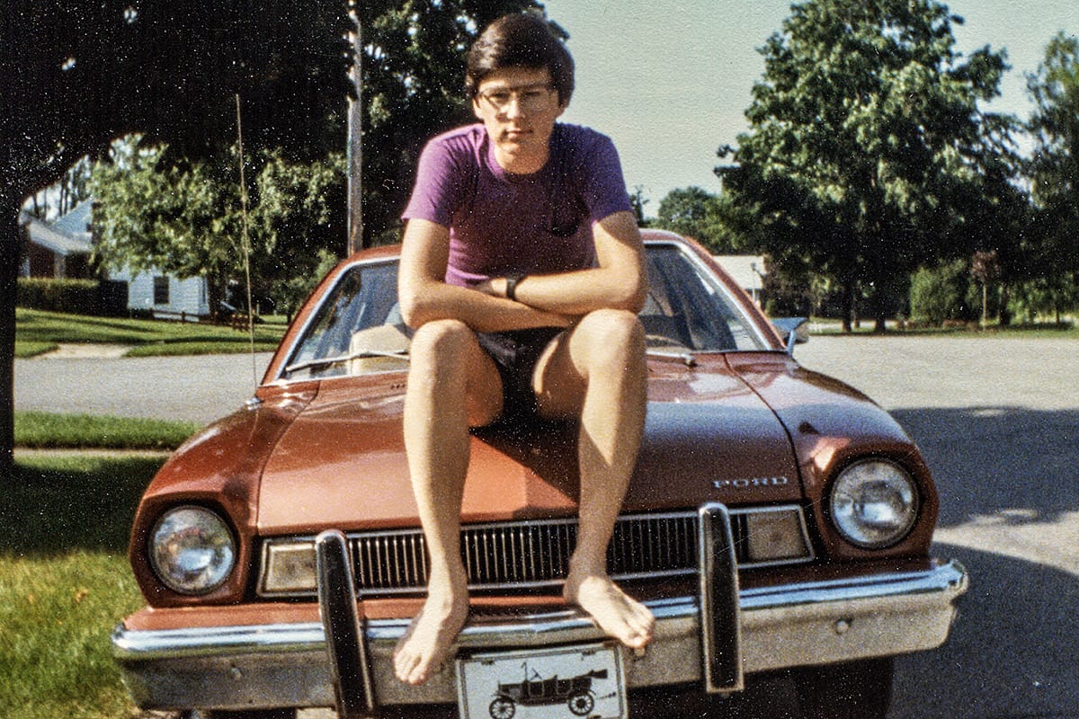 My 1975 Ford Pinto: Driving Into Confidence 1 Photo of a barefoot young man sitting on the hood of a 1975 Ford Pinto