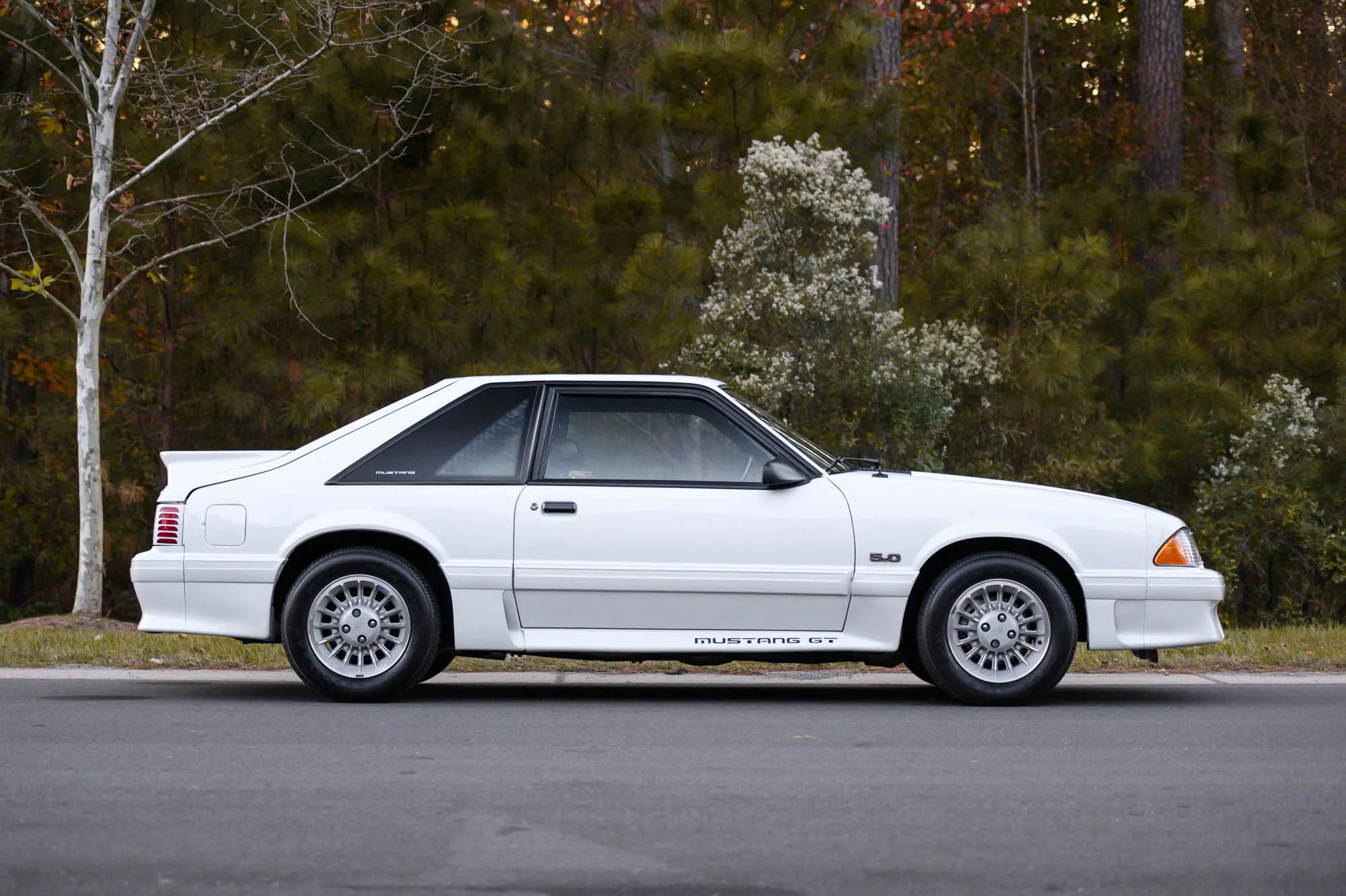Rare 1995 Ford Mustang GTS Was A Short-Lived Reinvention Of The Old LX 5.0L 2 Right side view of a white 1990 Ford Mustang GT hatchback