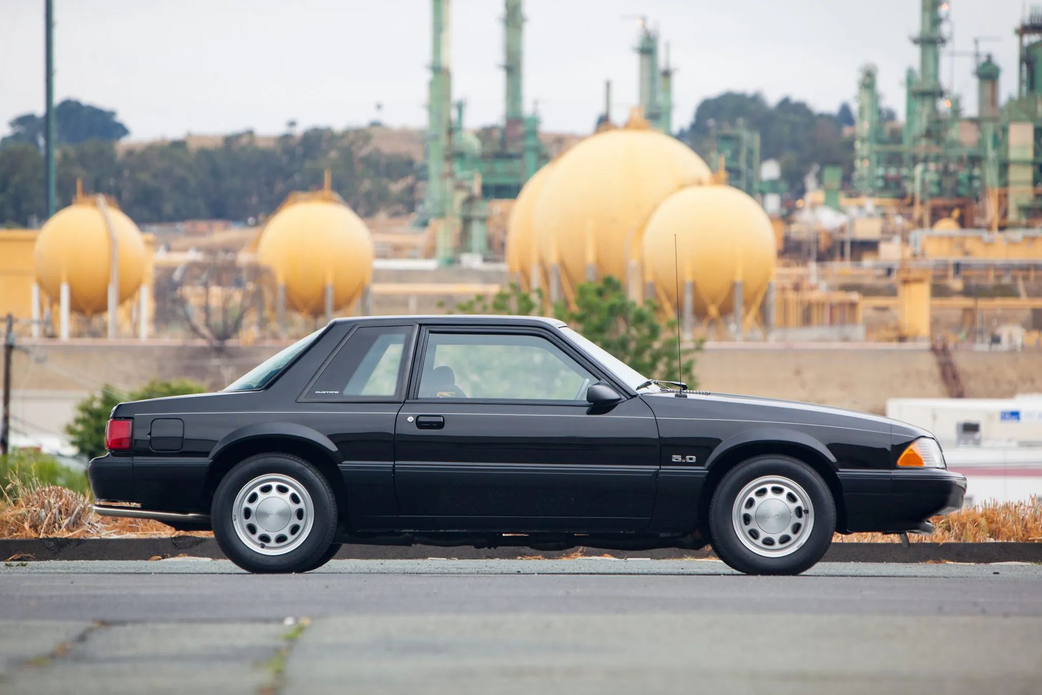 Rare 1995 Ford Mustang GTS Was A Short-Lived Reinvention Of The Old LX 5.0L 3 Right side view of a black 1990 Ford Mustang LX 5.0L notchback