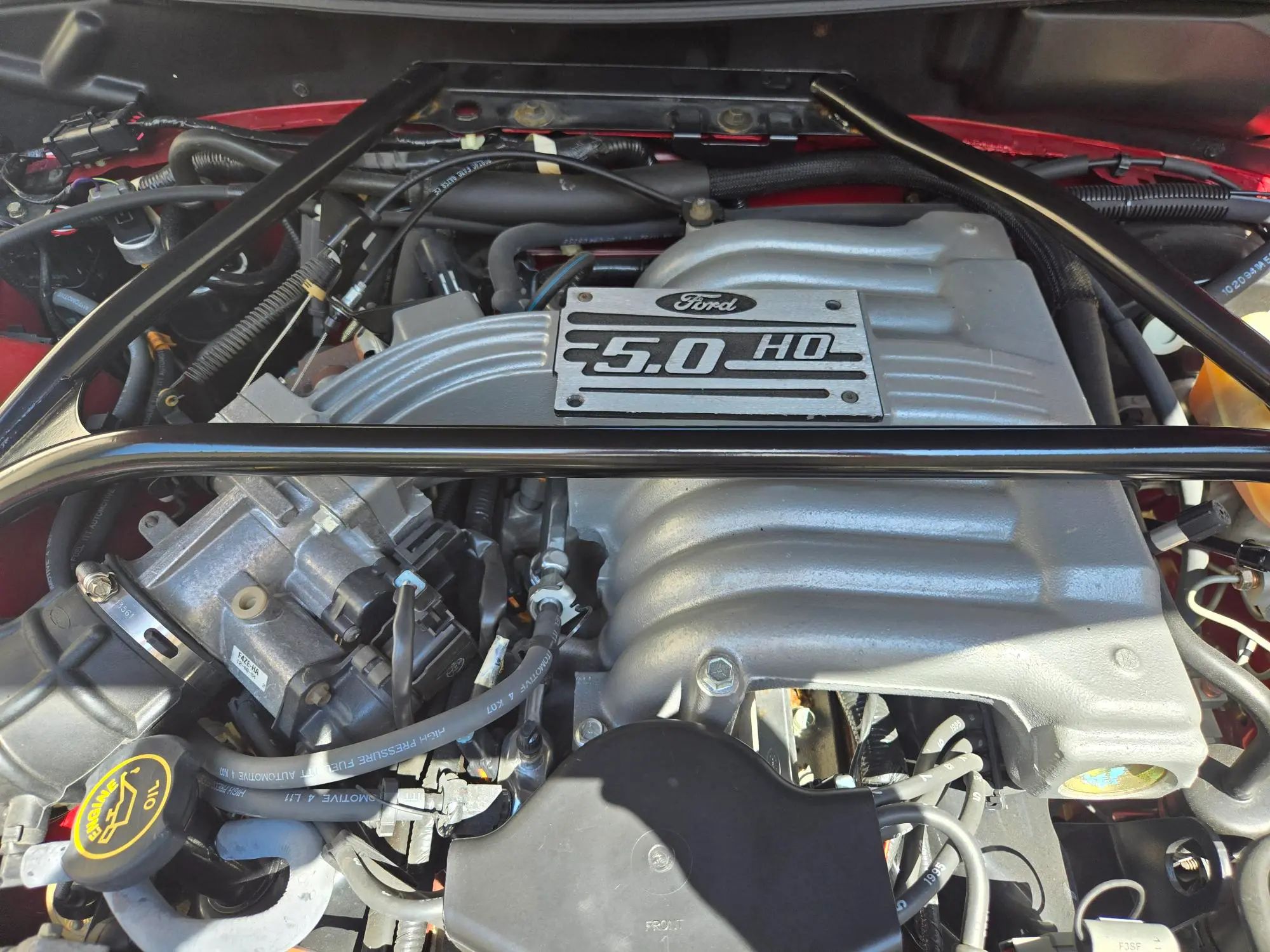 Rare 1995 Ford Mustang GTS Was A Short-Lived Reinvention Of The Old LX 5.0L 16 Ford 5.0 HO engine under the hood of a red 1995 Ford Mustang