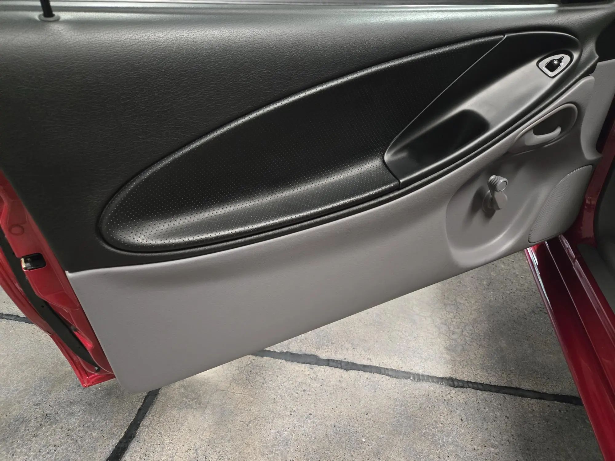 Rare 1995 Ford Mustang GTS Was A Short-Lived Reinvention Of The Old LX 5.0L 7 Driver's door trim of a 1995 Ford Mustang GTS, with a manual crank handle for the window