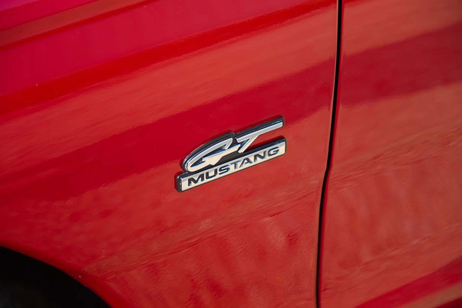 Rare 1995 Ford Mustang GTS Was A Short-Lived Reinvention Of The Old LX 5.0L 10 "GT Mustang" badge on the fender of a red 1995 Ford Mustang GTS coupe