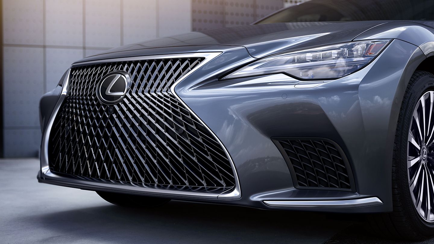 Press photo showing a close-up of the grille and nose of a gray 2025 Lexus LS