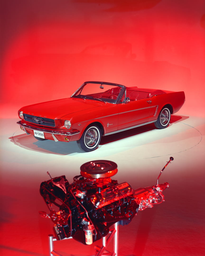 Ford's Famous 289 V-8: Four Production Changes That Could Ruin Your Day 1 Factory Image of Ford 289 High-Performance V8 in front of a Rangoon Red 1965 Mustang Convertible