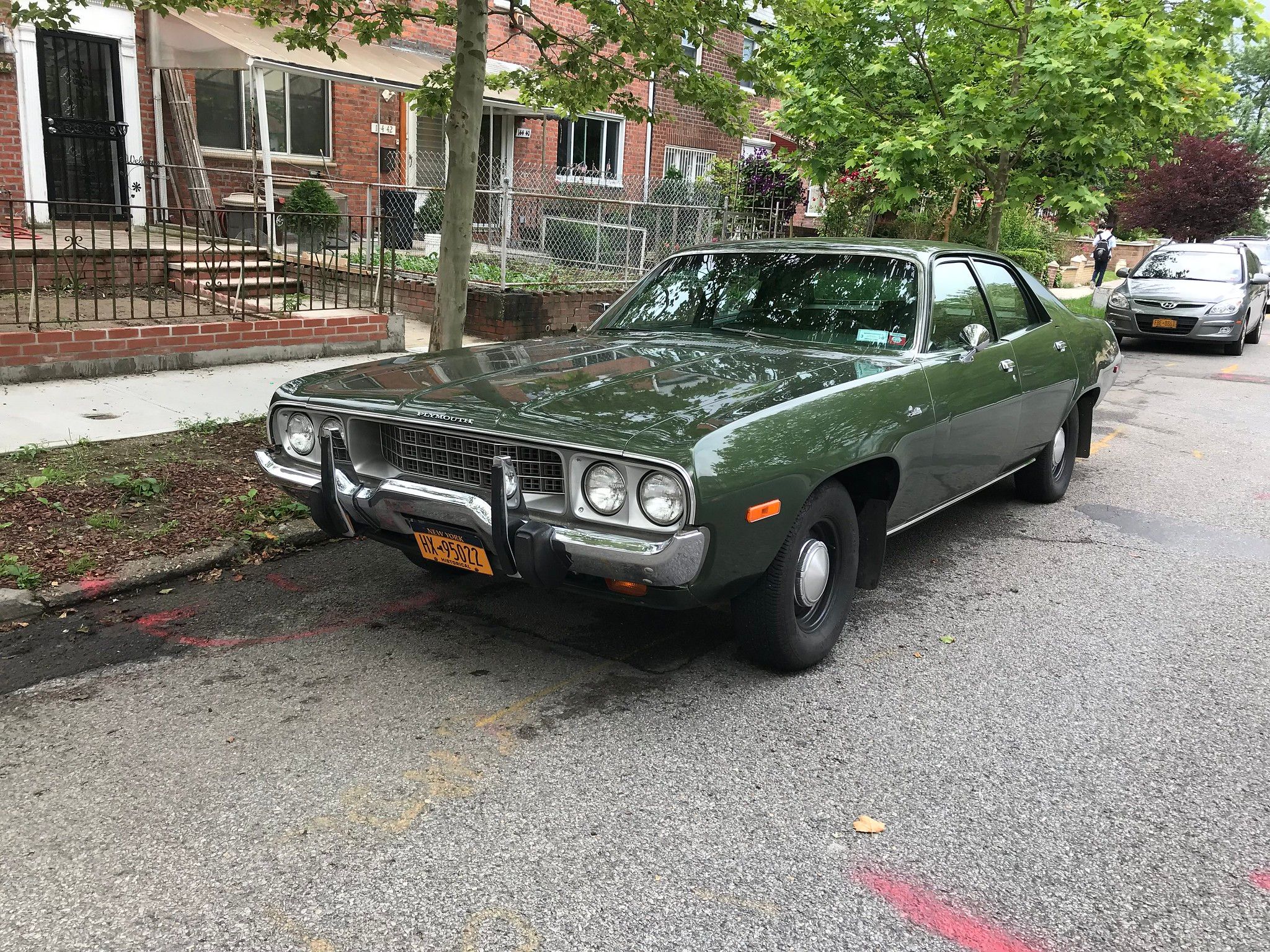 1973 Plymouth Satellite Sedan: A Torch Song On How To B-Sharp 1 Photo of a dark green 1973 Plymouth Satellite four-door sedan parked on a tree-lined street.
