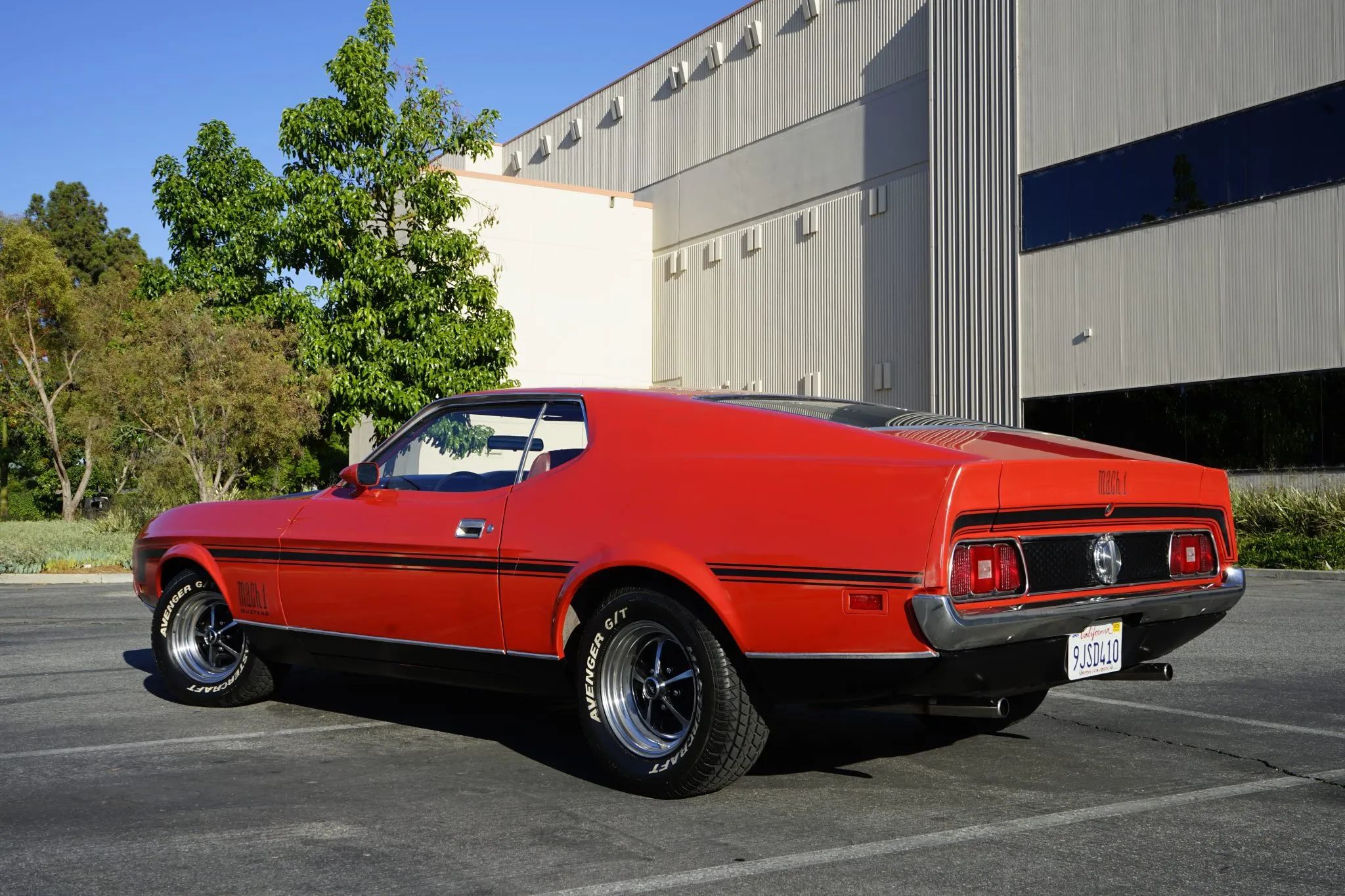 1971 Ford Mustangs: Every Color From Raven Black To Light Gold 16 Photo of 1971 Mustang Mach 1 in Bright Red in front of building