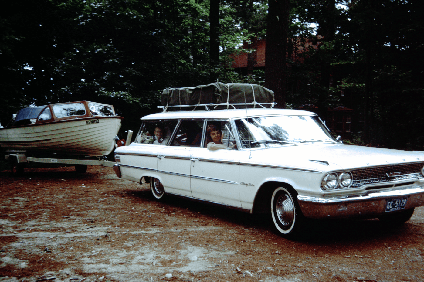 A Gallery Of Readers' Vintage Photos From The 1960s, 1970s, And 1980s 1 Vintage photo of a white 1963 Ford Country Sedan pulling a boat in a forested area.