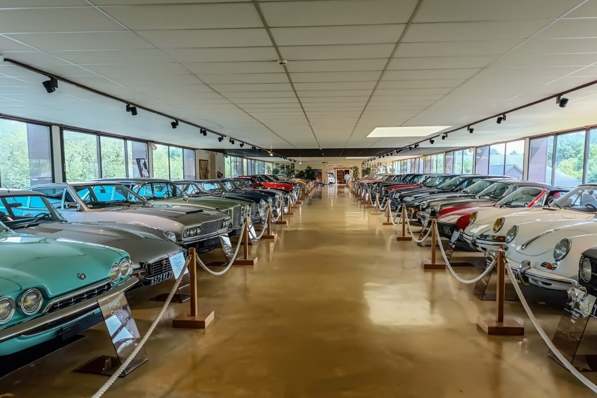 Photo of two rows of cars in an automotive museum