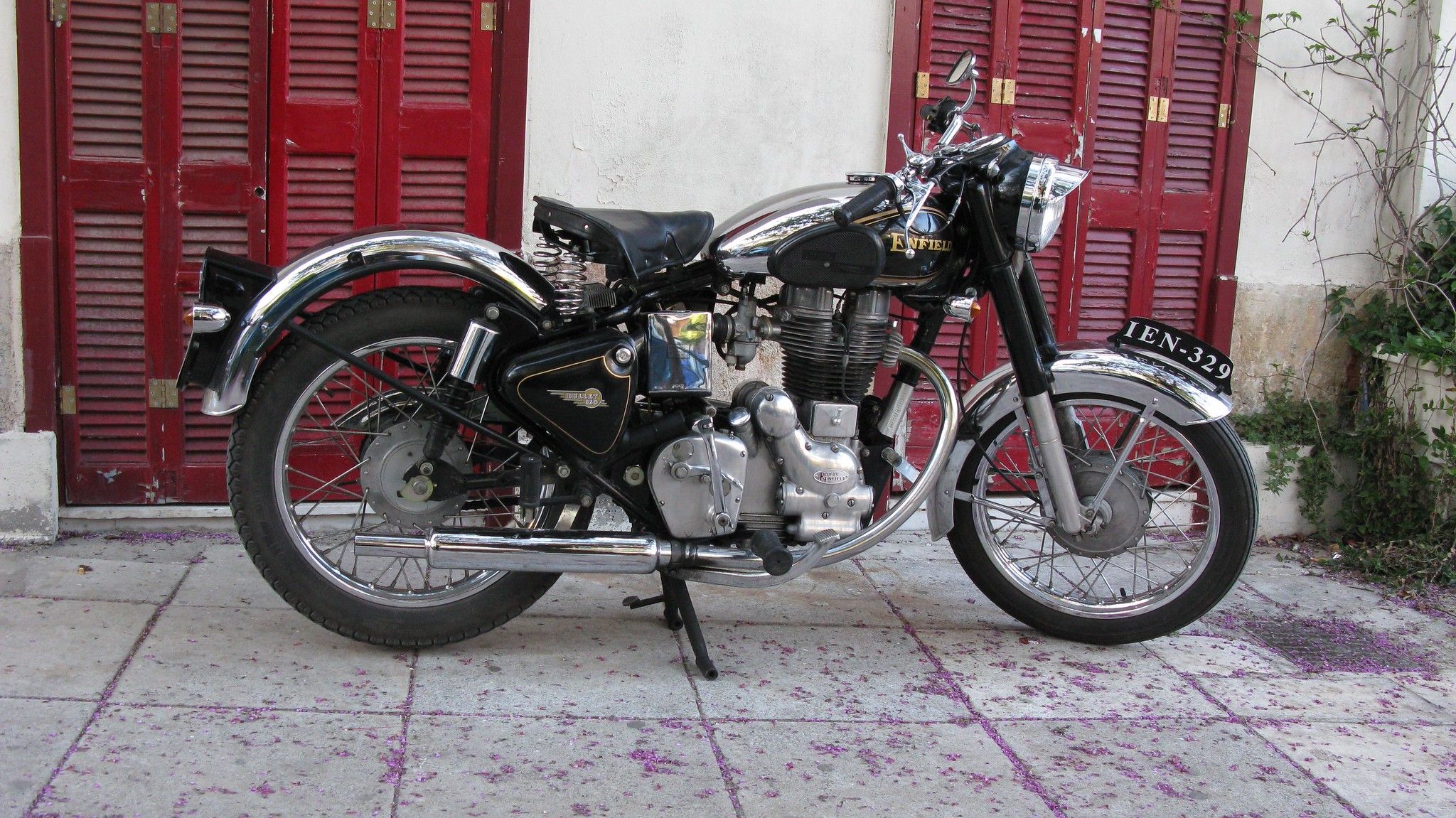 Royal Enfield Bullet: A Storied Motorcycle That's Built like A Gun, Goes Like A Bullet 1 Profile view of a black Royal Enfield motorcycle.