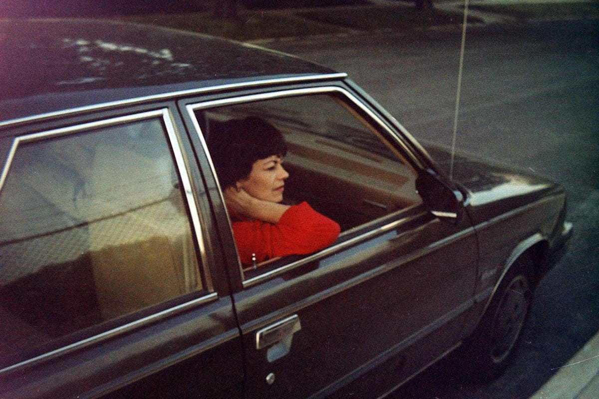 Photo of a woman in the passenger seat of a black Renault