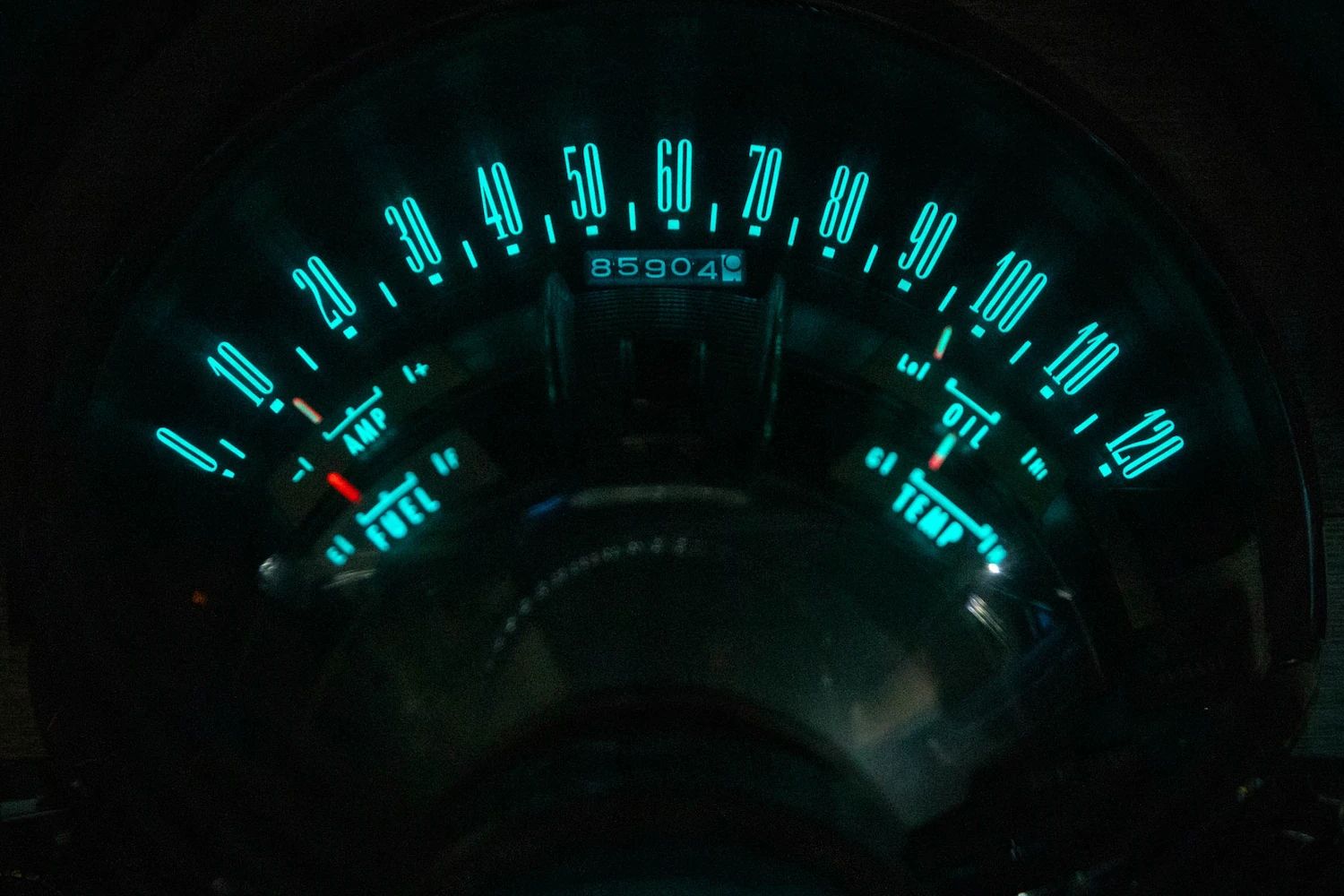 Blue-green instrument lighting of a 1960 Chrysler New Yorker, photographed in the dark