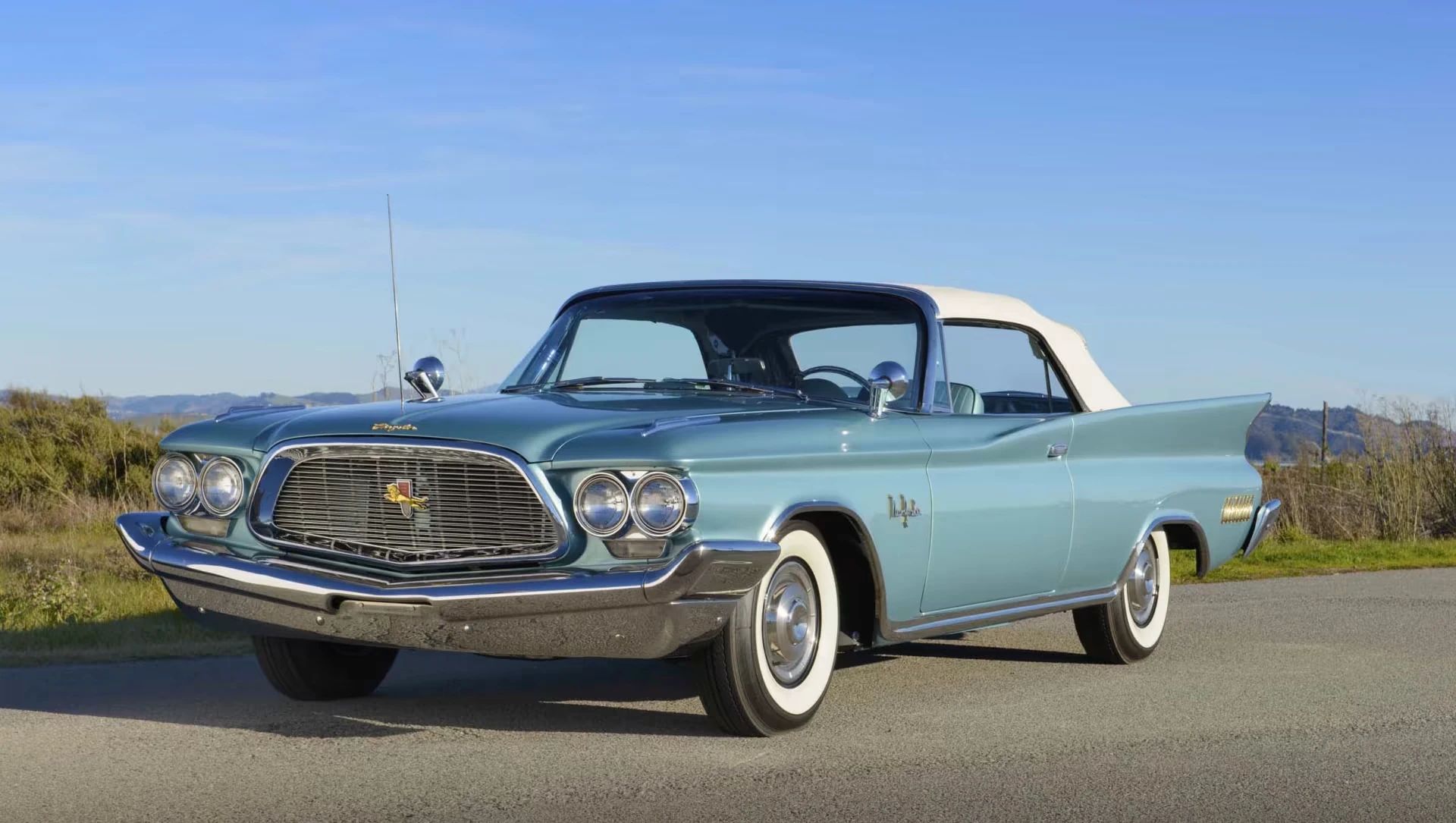 Left front 3q view of a turquoise 1960 Chrysler New Yorker convertible with its top up