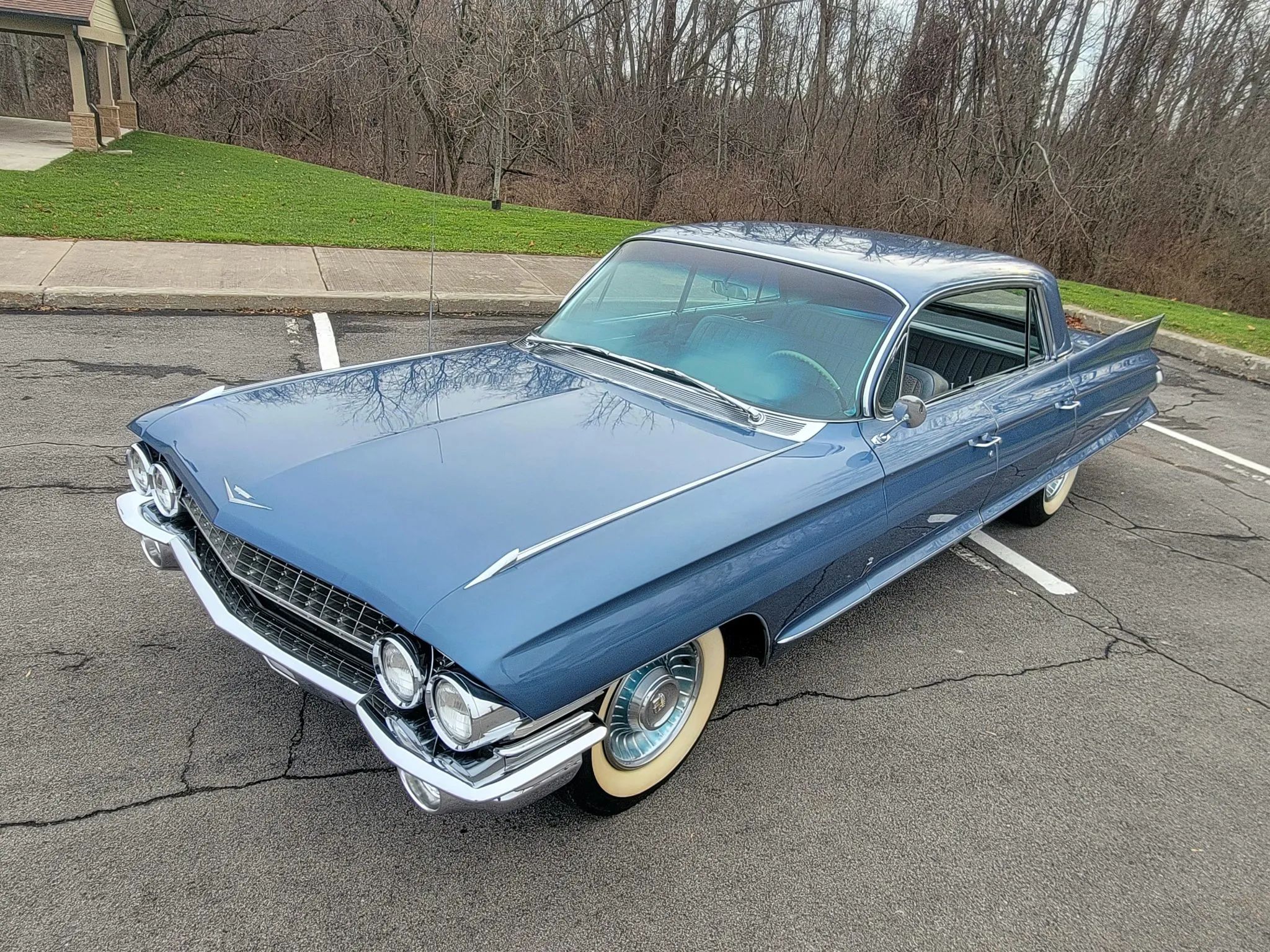 High-angle left front 3q view of a blue 1961 Cadillac Sixty Special four-door hardtop