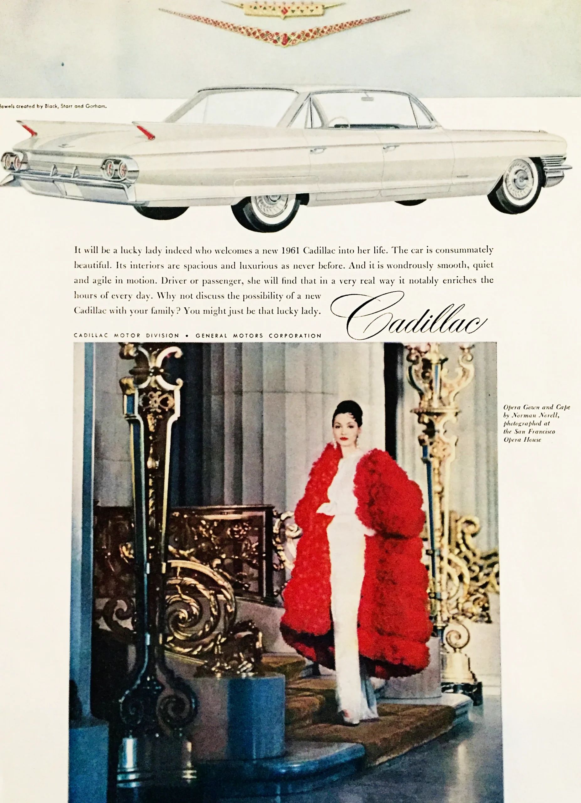 Cadillac ad showing a white 1961 6-window Sedan de Ville with a jeweled necklace in the shape of the Cadillac shield and crest, above a photo of a woman in a white dress and red cape outside a formal-looking structure