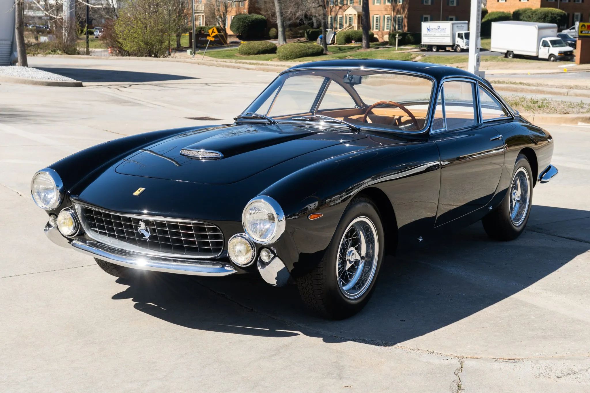 Pininfarina's Shared Language of Beauty in 1963—From Ferrari to FIAT 16 Image of black 1963 Ferrari 250 GT Lusso in a sunny parking lot