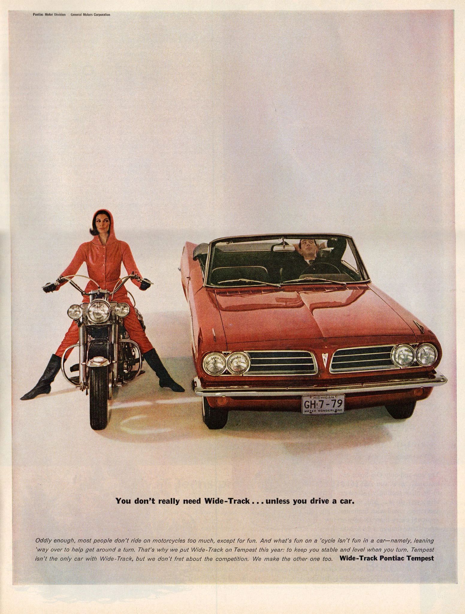 Pontiac ad showing a man leaning back behind the wheel of a red 1963 Pontiac Tempest convertible stopped next to a dark-haired woman in a red hooded jumpsuit and black leather boots on a motorcycle, with the headline, "You don't really need Wide-Track…unless you drive a car."