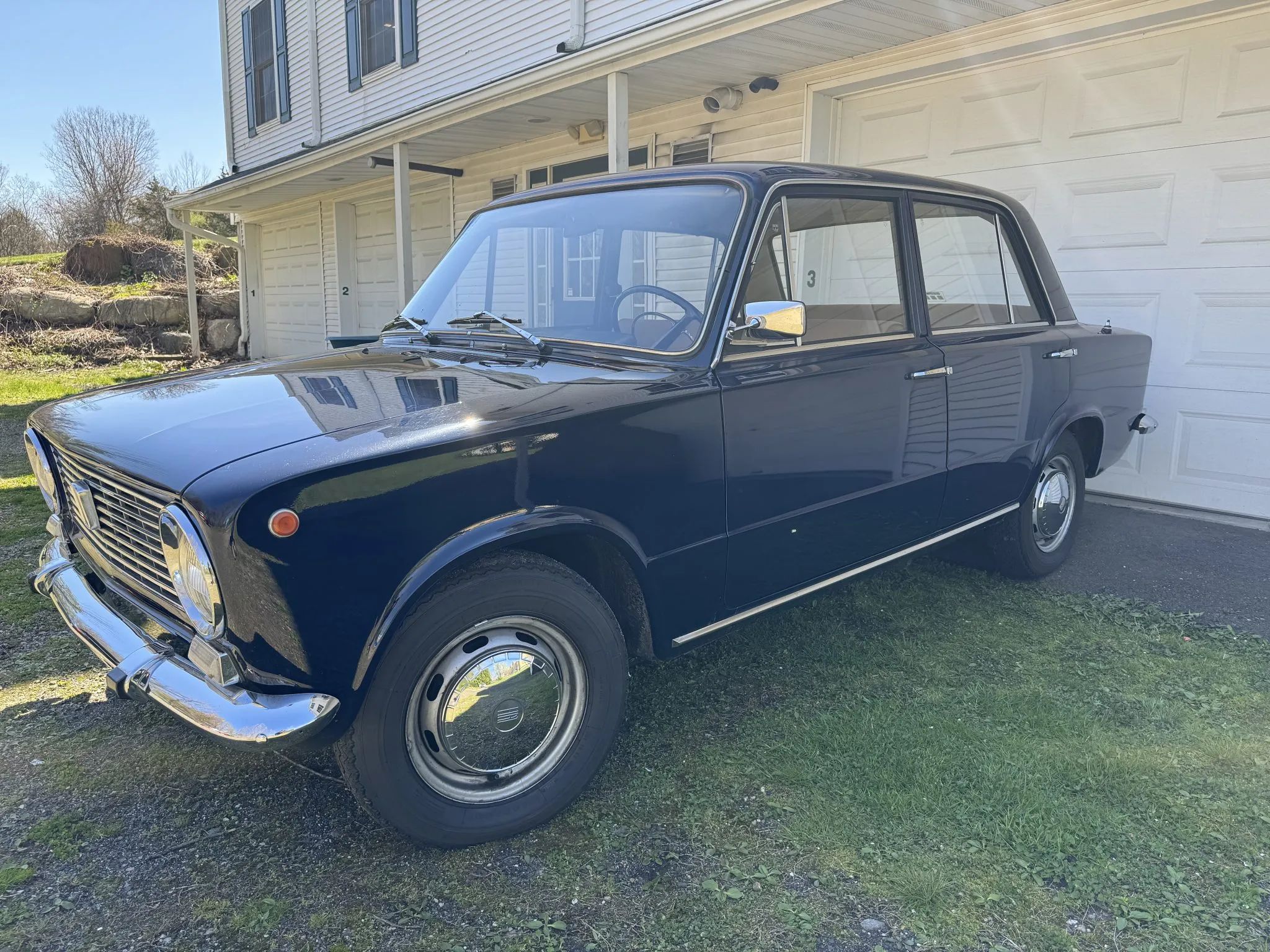 Left front 3q view of a dark blue 1969 Fiat 124 sedan