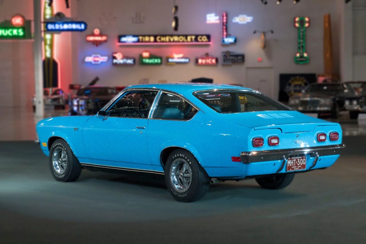 Left rear 3q view of a blue 1971 Chevrolet Vega three-door coupe in an indoor museum space