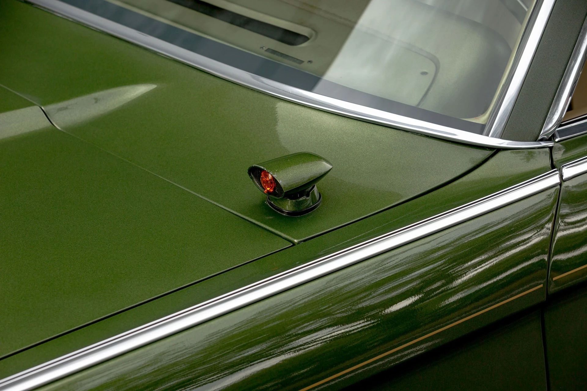 Headlight dimmer sensor pod on the hood of a green 1971 Lincoln Mark III
